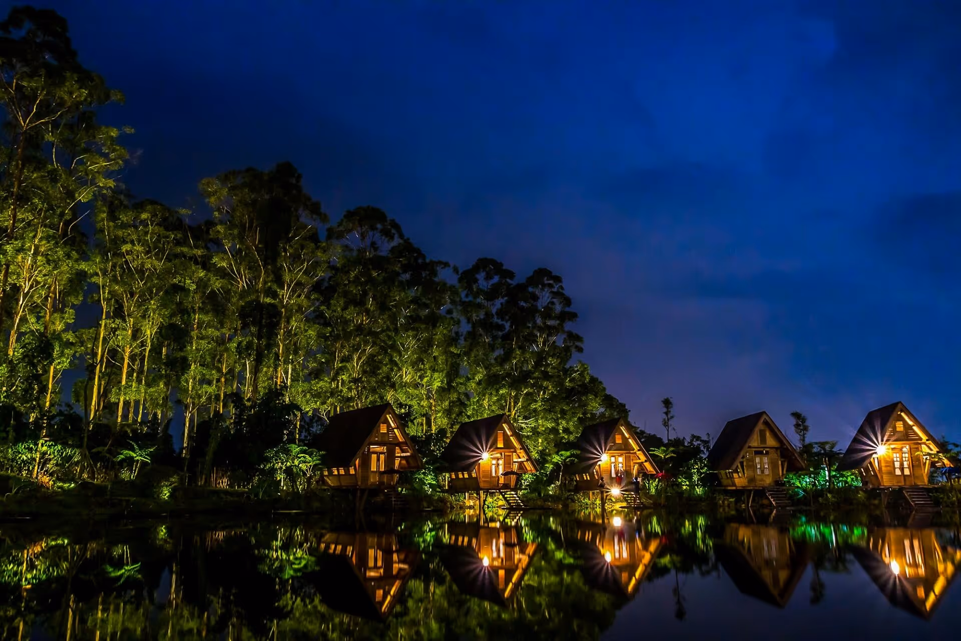 Wooden House Near Body of Water during Night Time