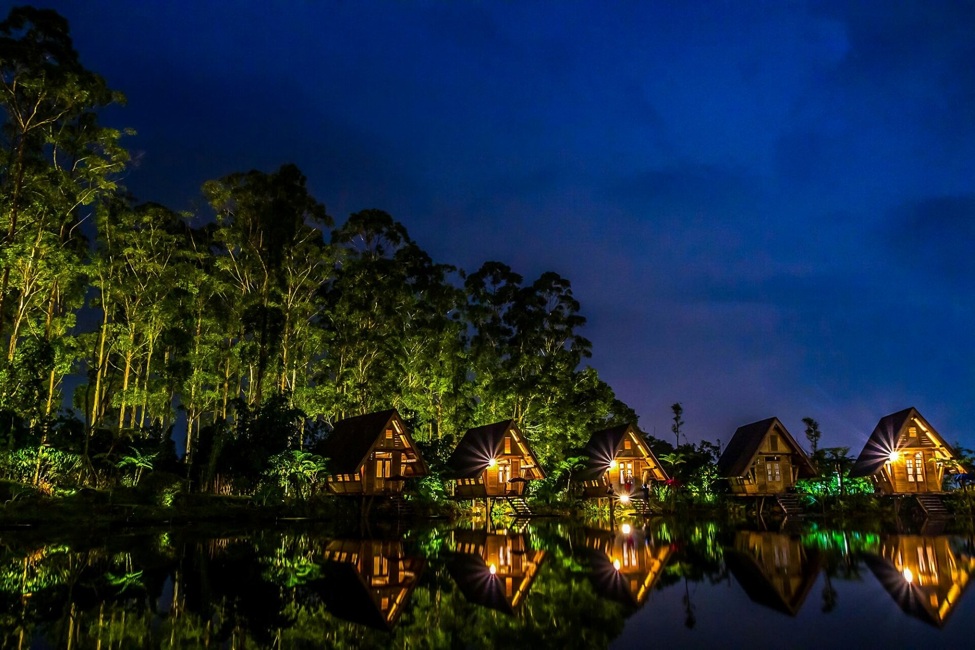 Wooden House Near Body of Water during Night Time
