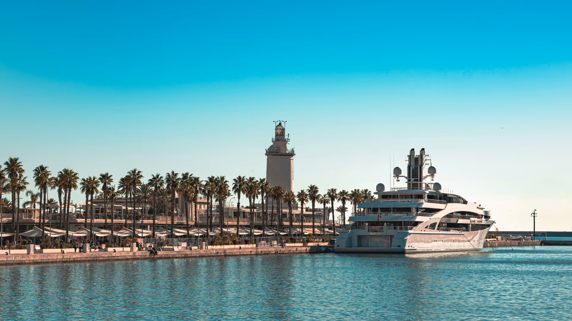 Luxury yacht docks near a beautiful coastal city