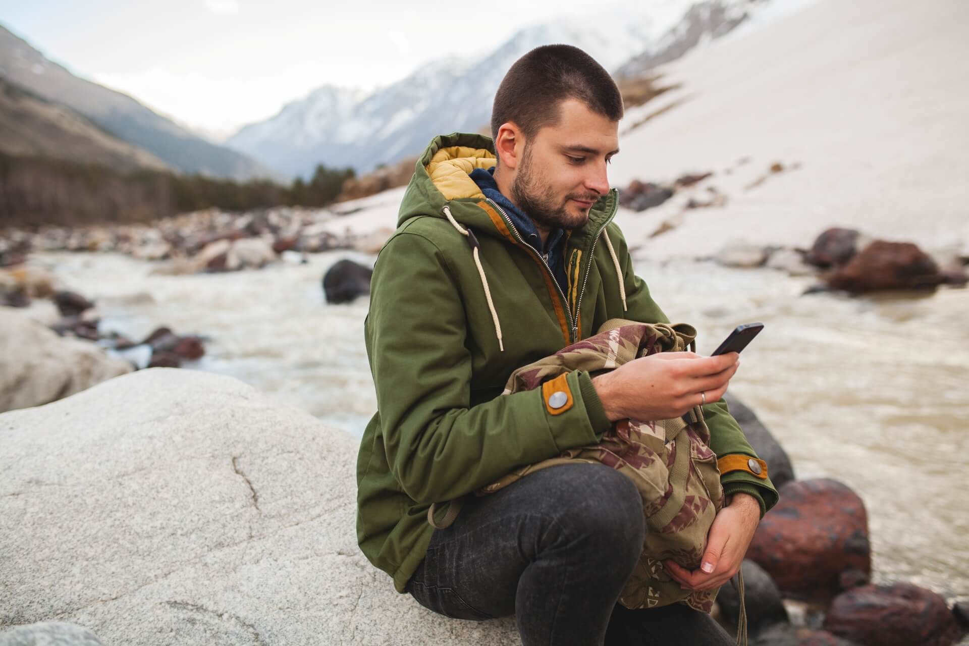 man using smartphone while hiking