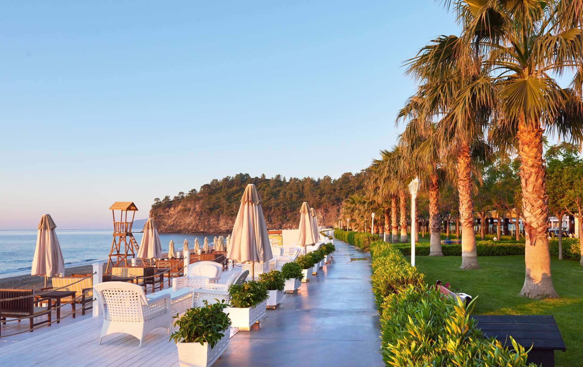 Scenic view of private sandy beach with sun beds
