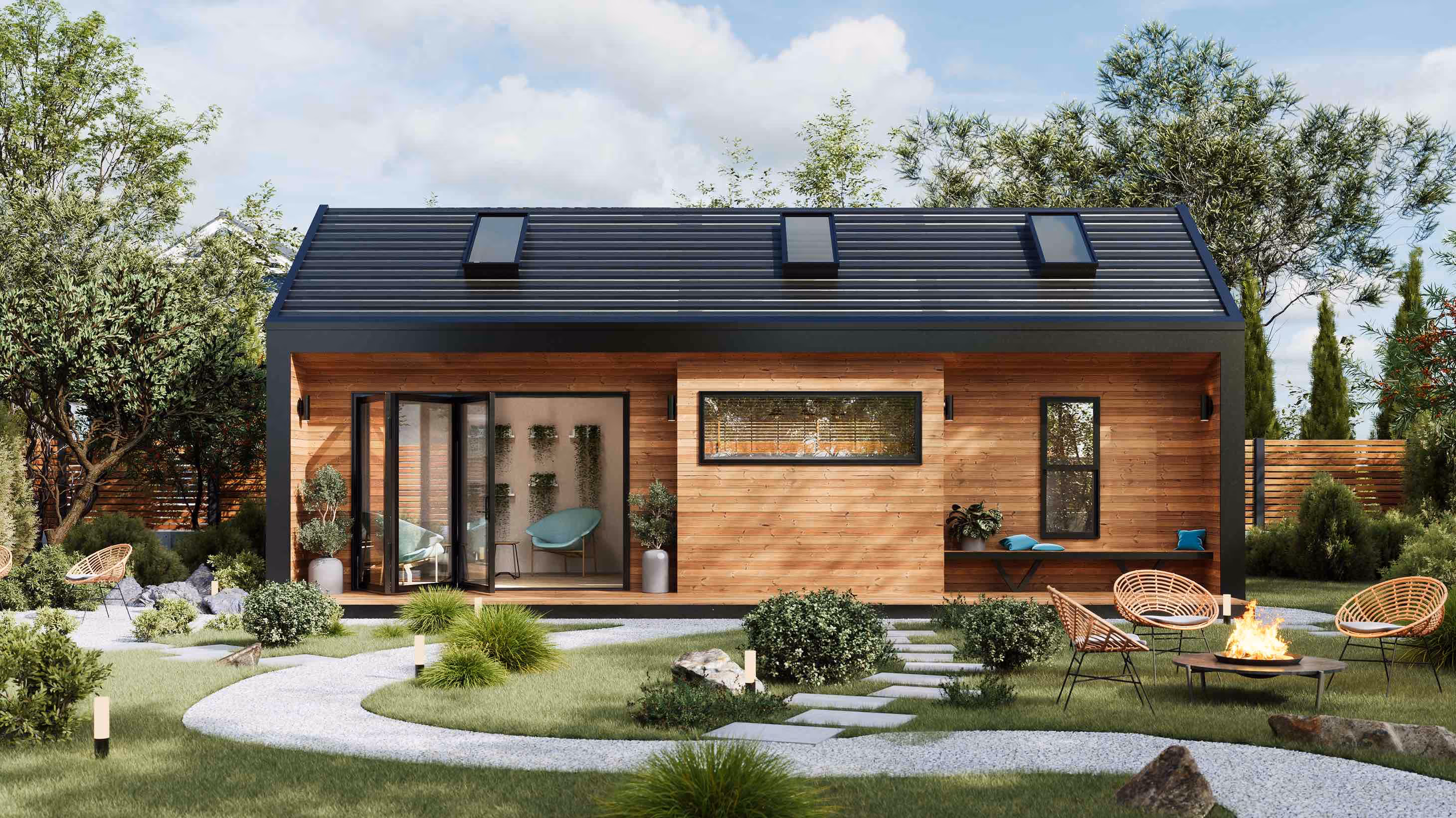 Modern prefab ADU with pitched roof, skylights and mezzanine level with a stone pathway in a well-maintained backyard