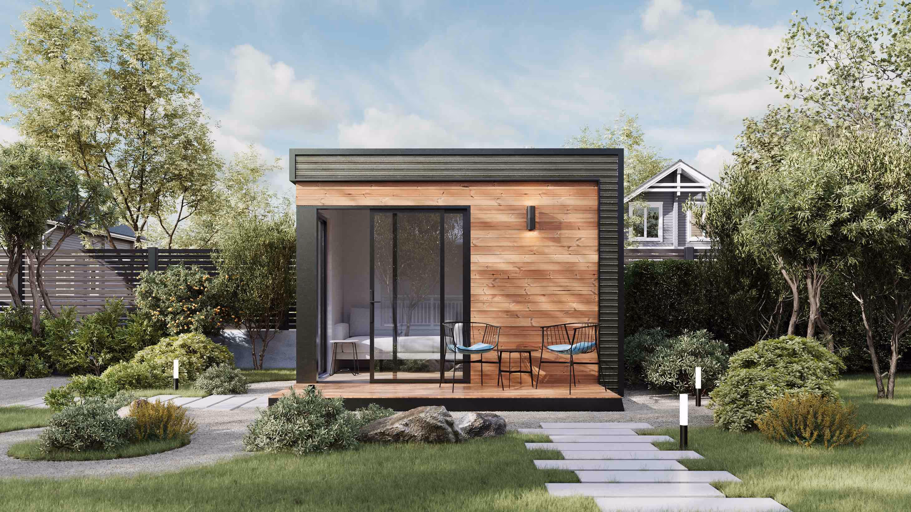 Sunset Mini studio shed with a wooden exterior and black framed glass door.