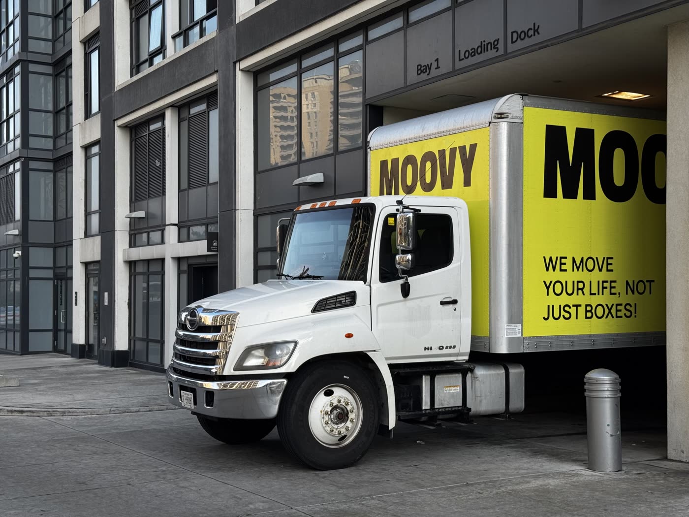Moovy moving truck parked at a Toronto condo building loading dock