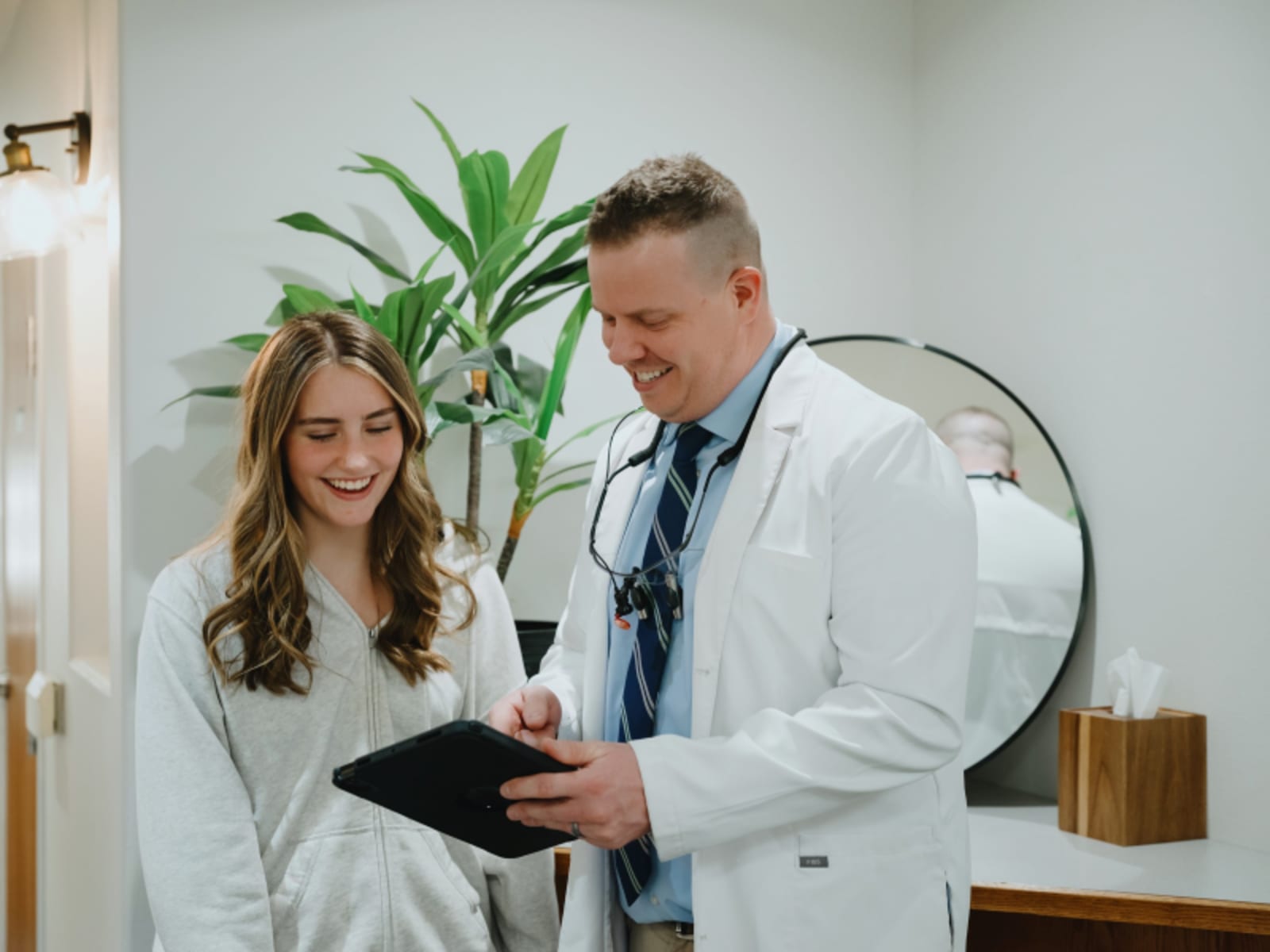 Dentist discussing treatment options with female patient in clinical setting