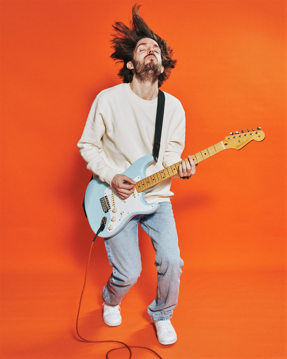 Seán Frayne with electric guitar