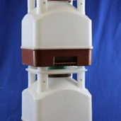 White and brown plastic device with a sensor or slot against a blue background.