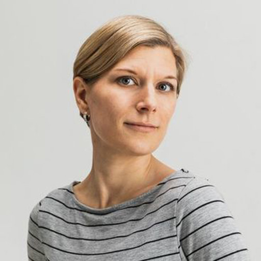 A woman in a striped shirt is looking at the camera.