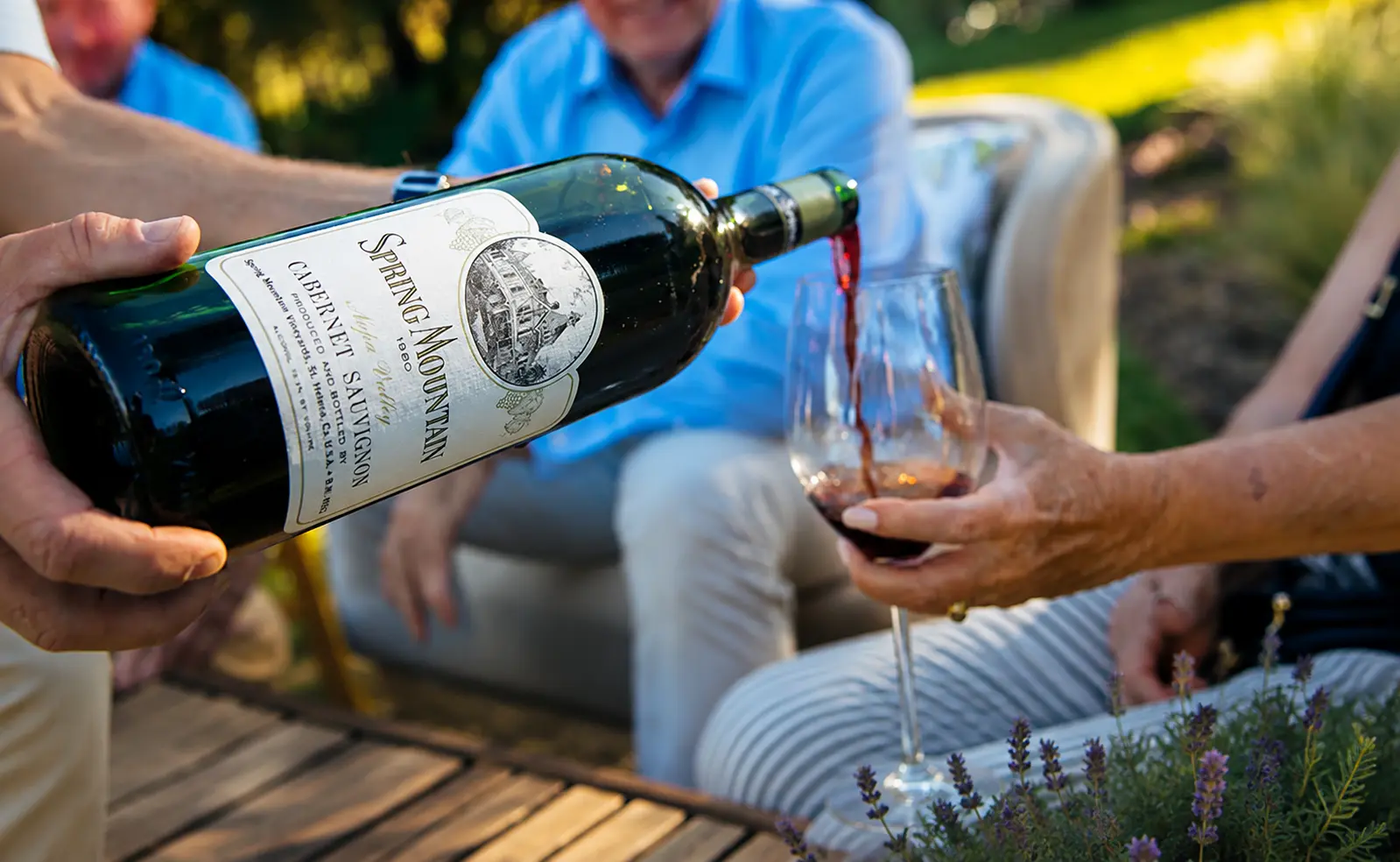 A bottle of Spring Mountain Vineyard 1980 Cabernet Sauvignon being poured into a glass during a Forged by Founders wine tasting experience at the vineyard.
