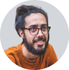 man with glasses and beard smiling at camera