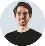 a close up of a man wearing glasses and a black shirt with Smiling Pose Looking at Camera