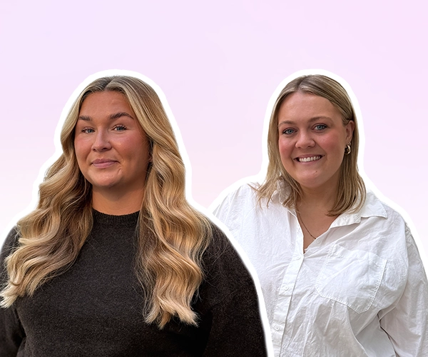 Two women standing side by side against a light pink gradient background, smiling, shown as cut-out portraits.