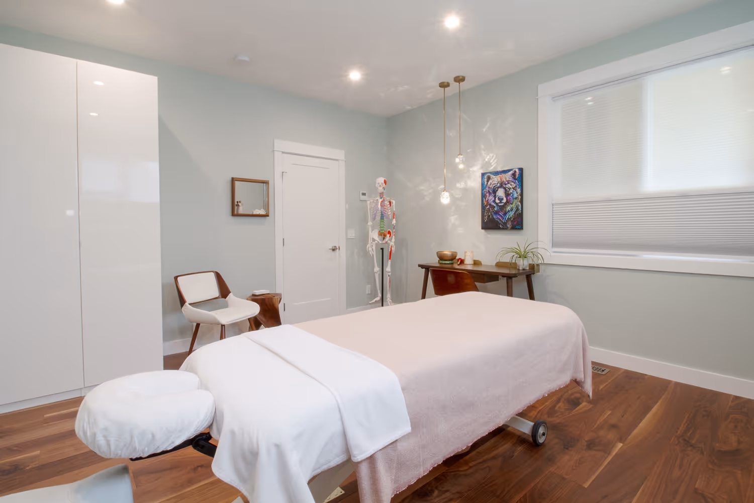 Massage table in pale green massage room.