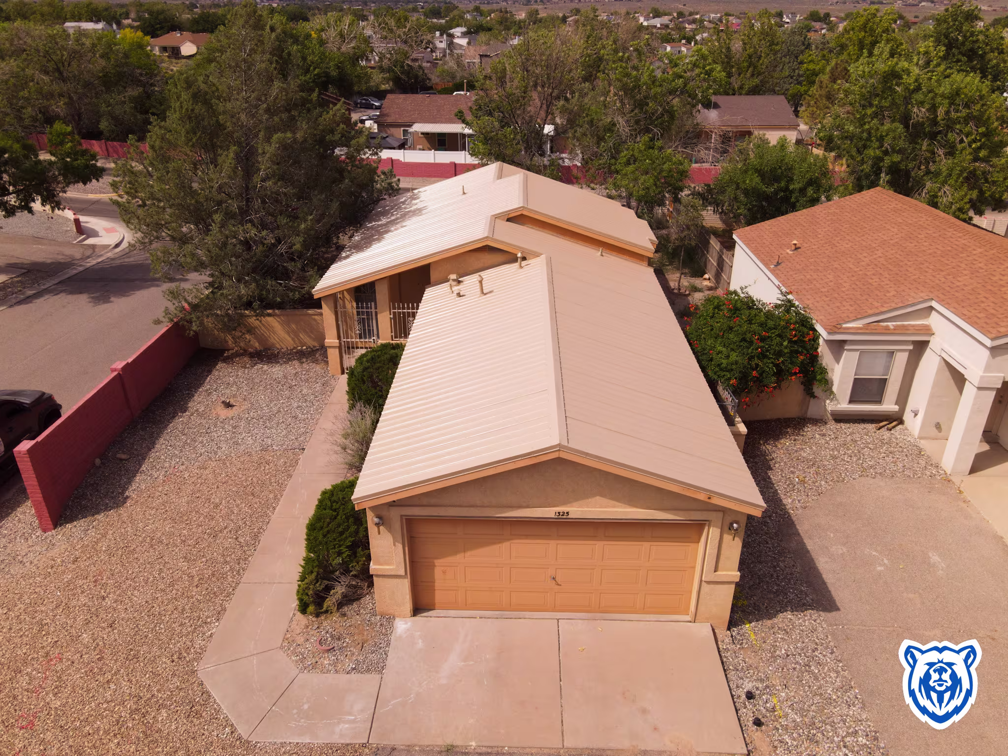 roof replacement with saddle tan metal panels in Rio Rancho, NM