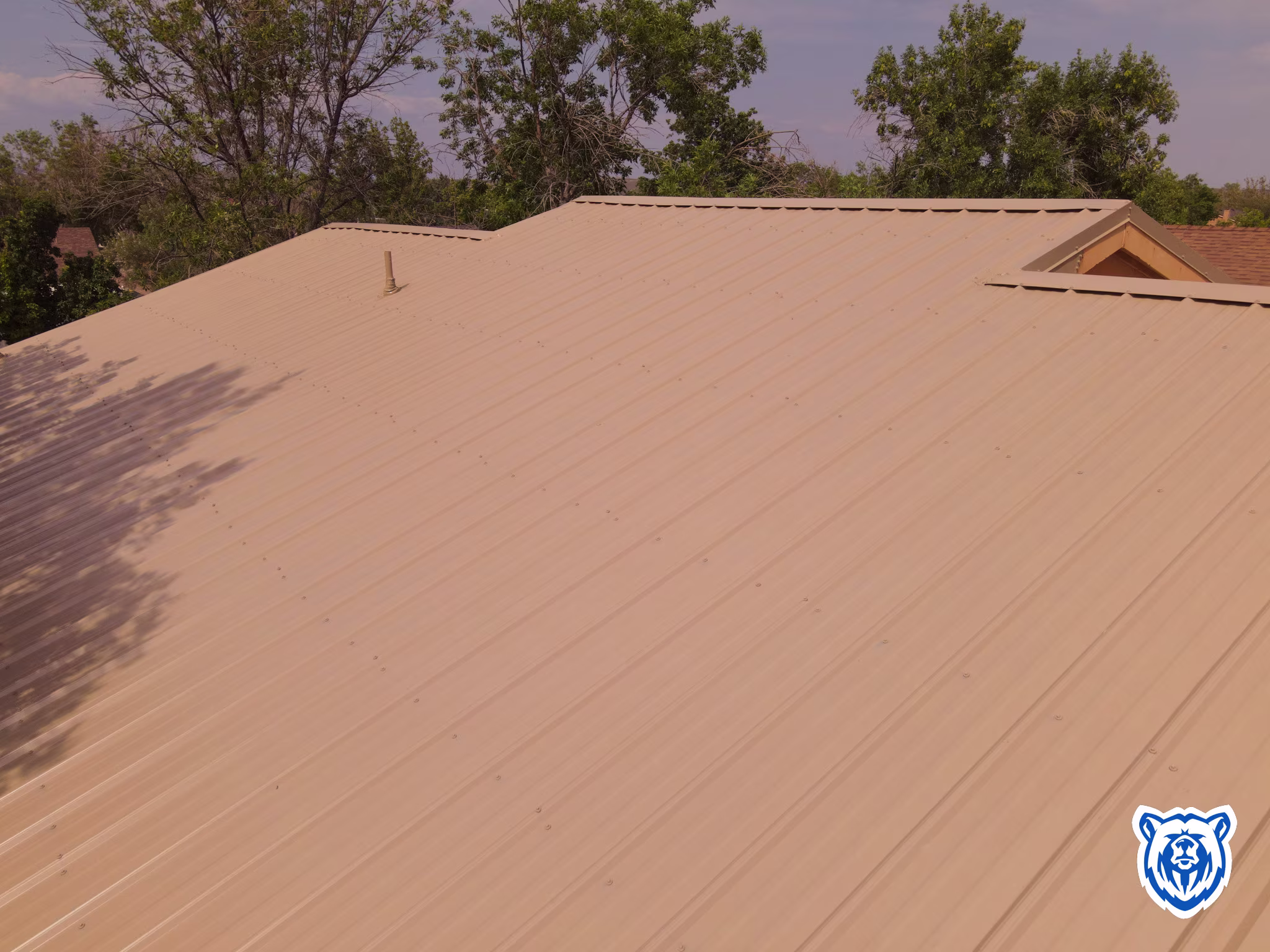 roof replacement with saddle tan metal panels in Rio Rancho, NM