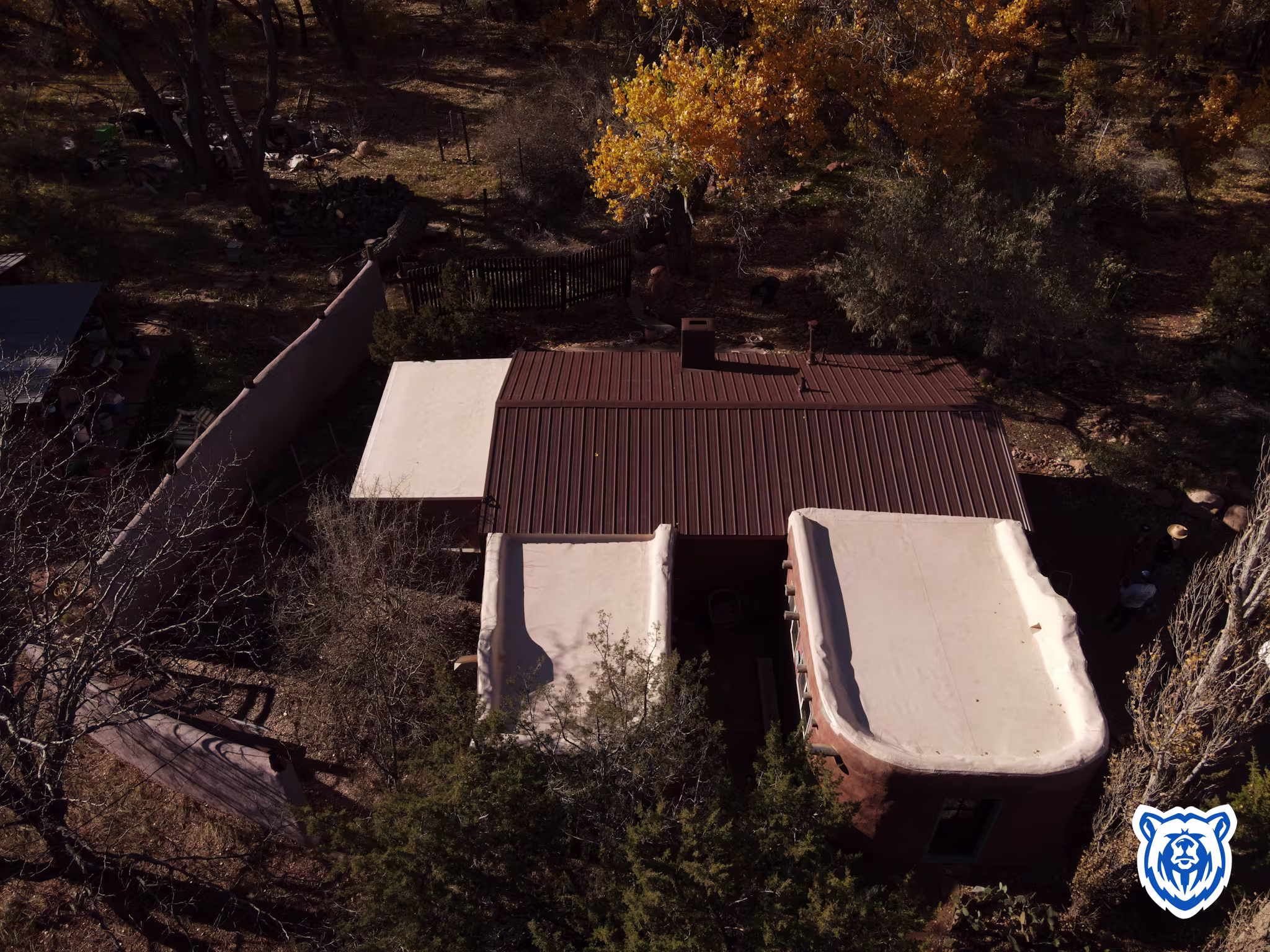 Mixed roof replacement with new cocoa brown metal panels and tan TPO