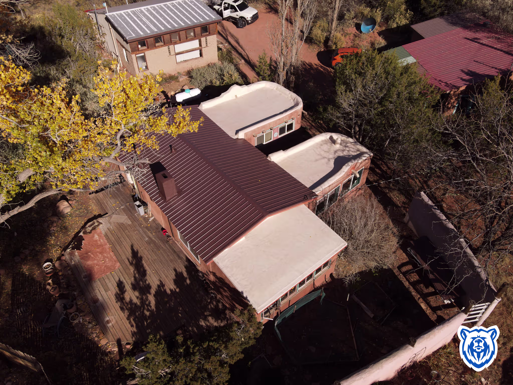 Mixed roof replacement with new cocoa brown metal panels and tan TPO