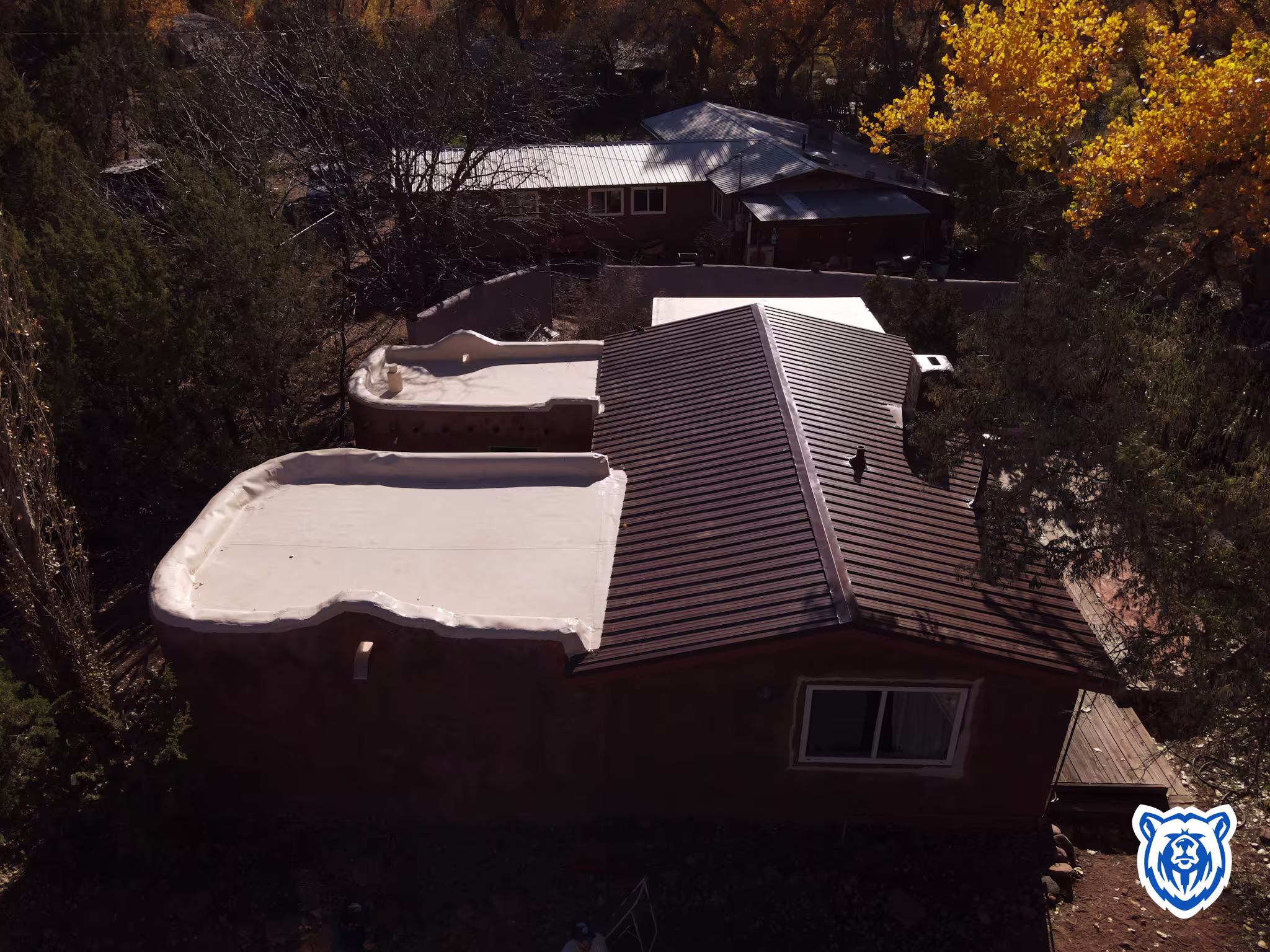 Mixed roof replacement with new cocoa brown metal panels and tan TPO