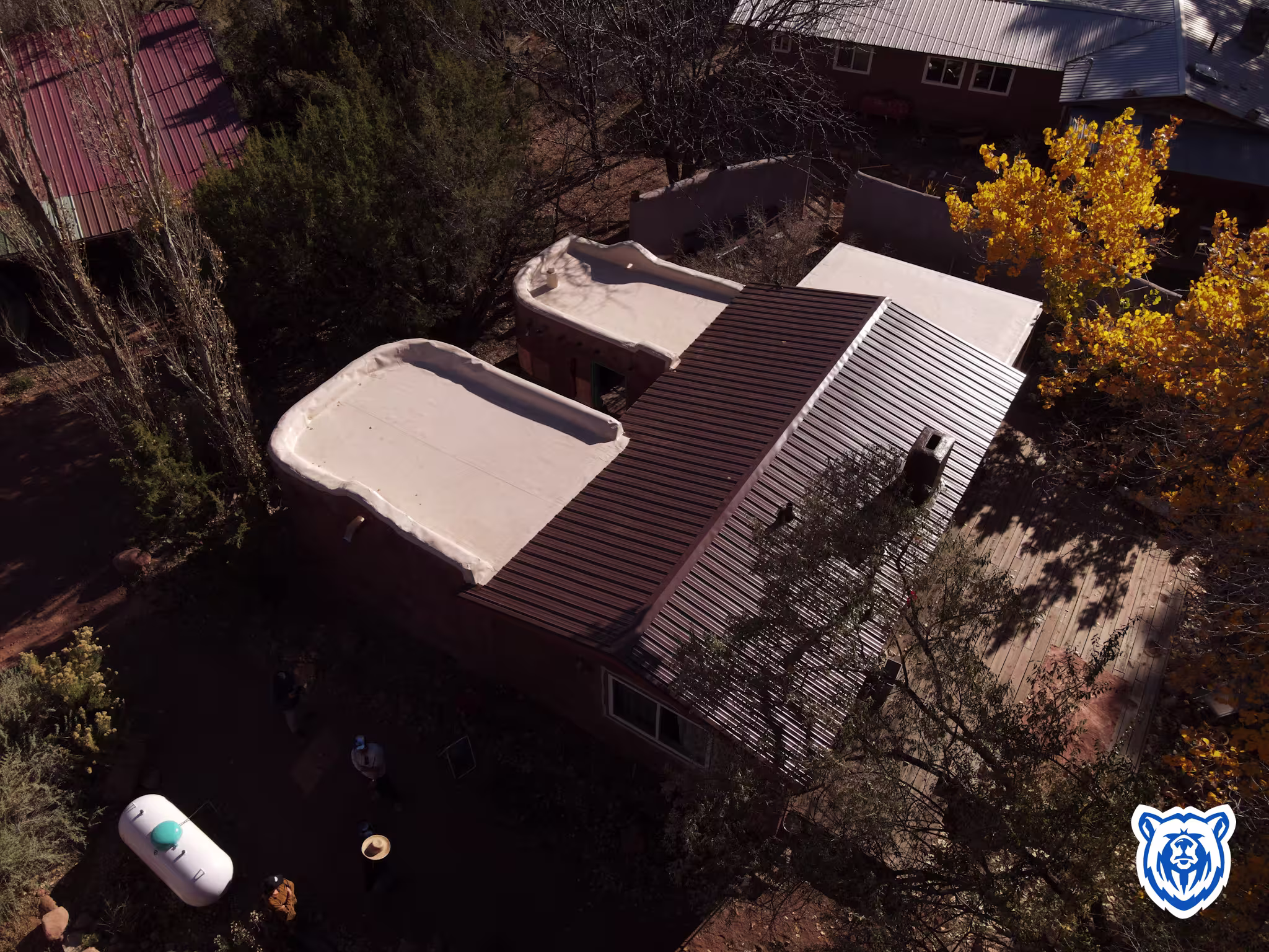 Mixed roof replacement with new cocoa brown metal panels and tan TPO