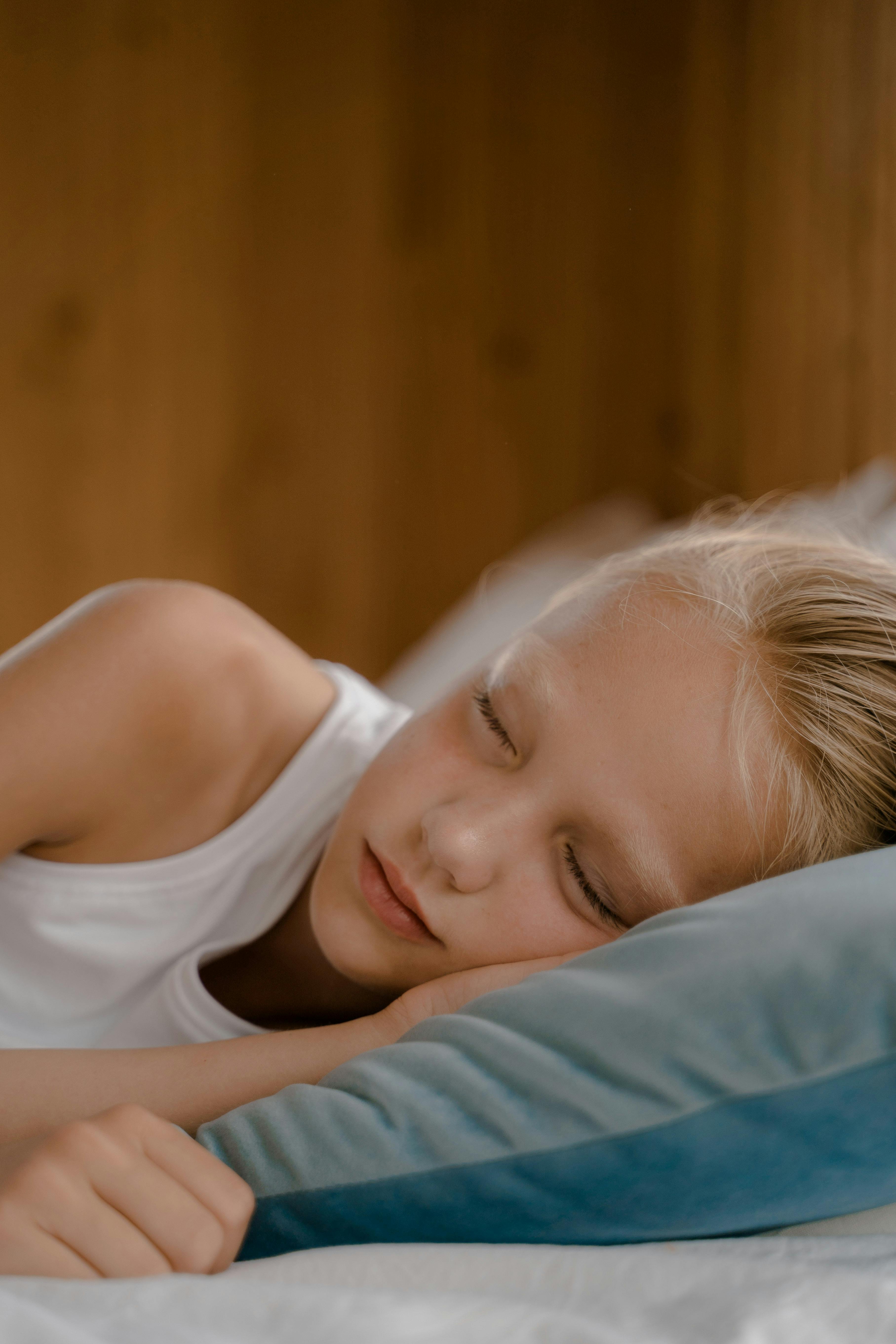 Ashwagandha supplement bottle on a table with a child sleeping peacefully in the background