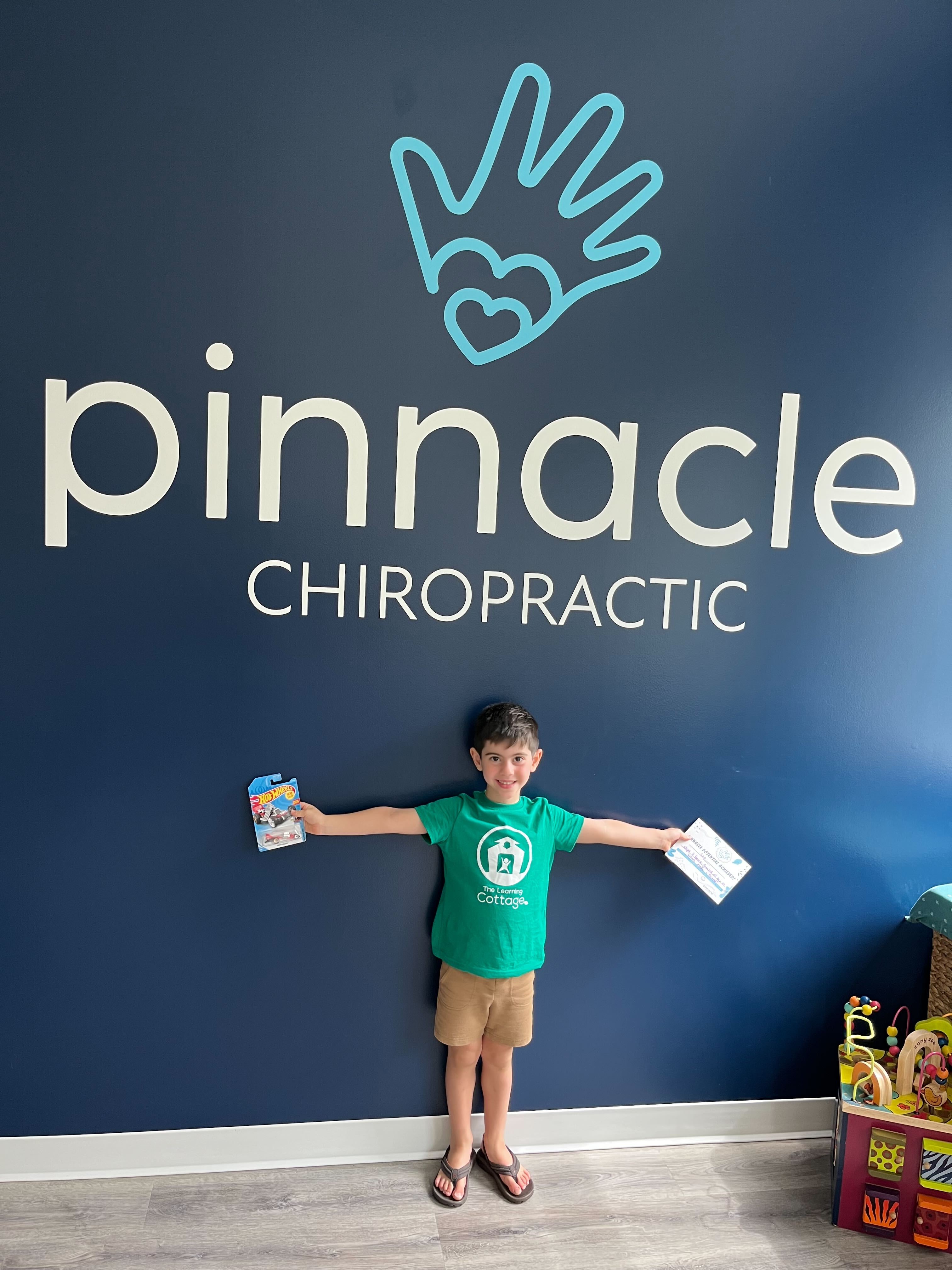 Chiropractic clinic with child-friendly toys and logo, promoting family care and wellness for stress-free kids in Sarasota.