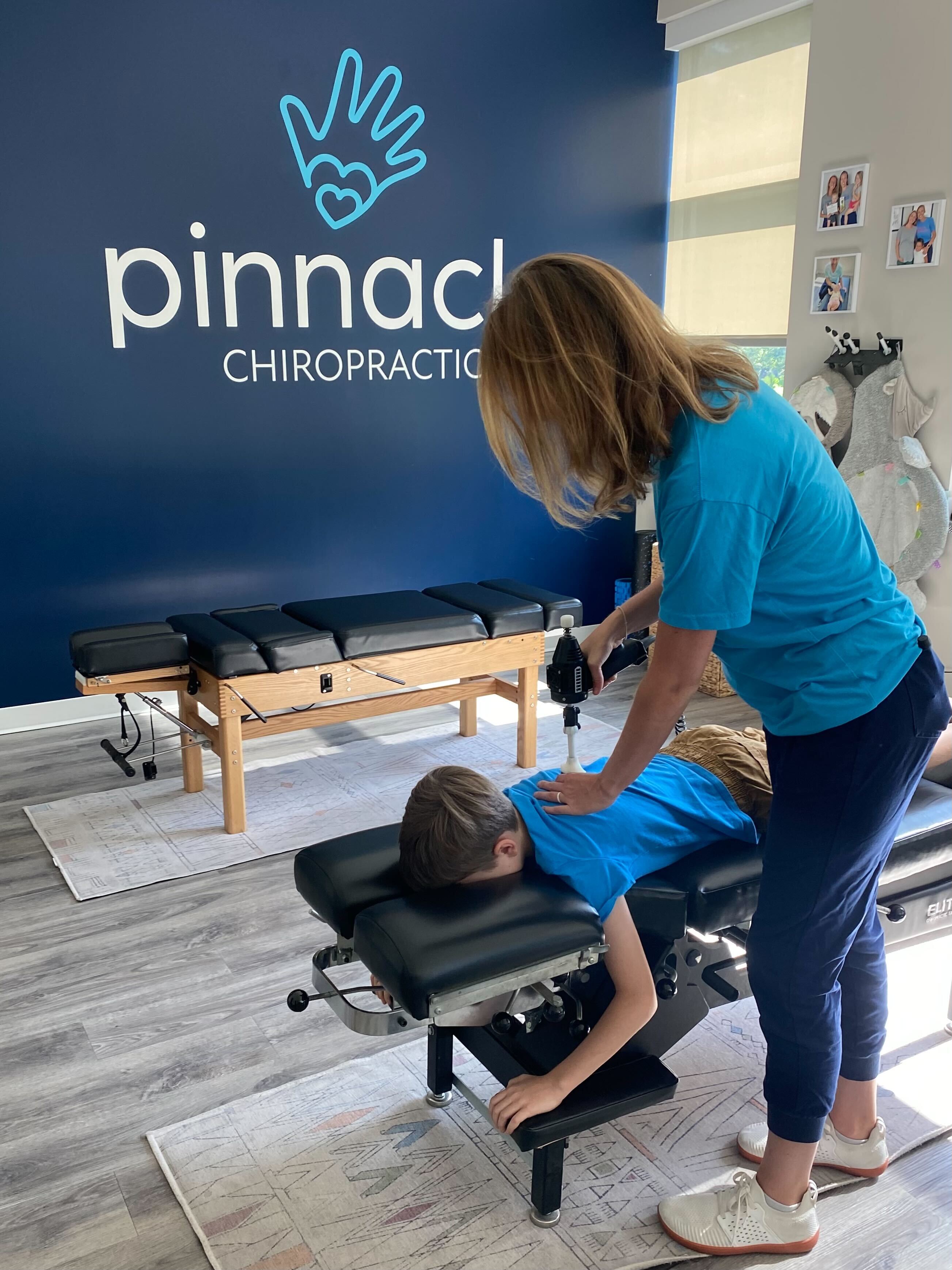 Pediatric chiropractor examining a child’s spine for scoliosis signs.