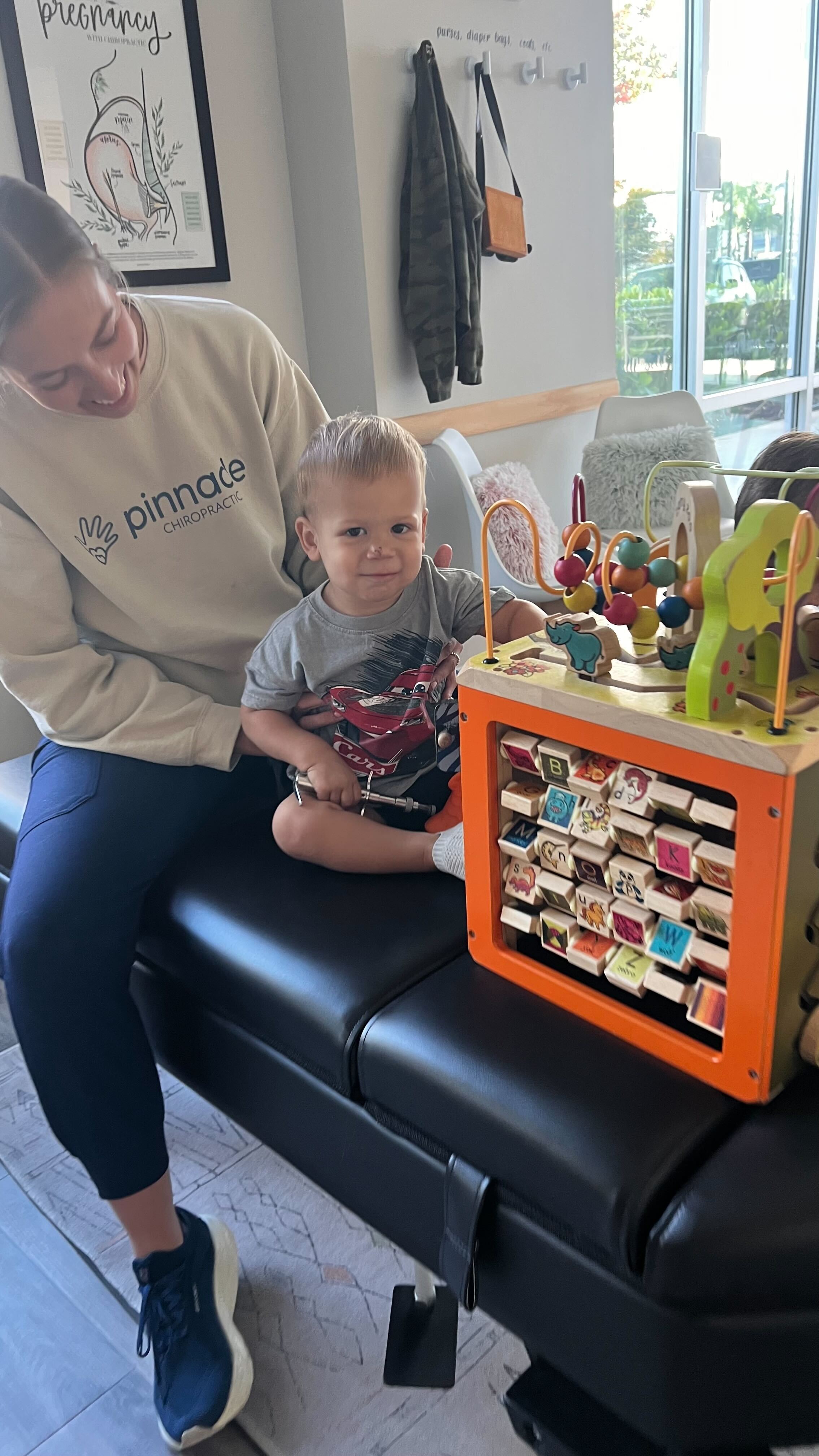 A toddler receives a nervous system based chiropractic adjustment as part of a personalized care plan.