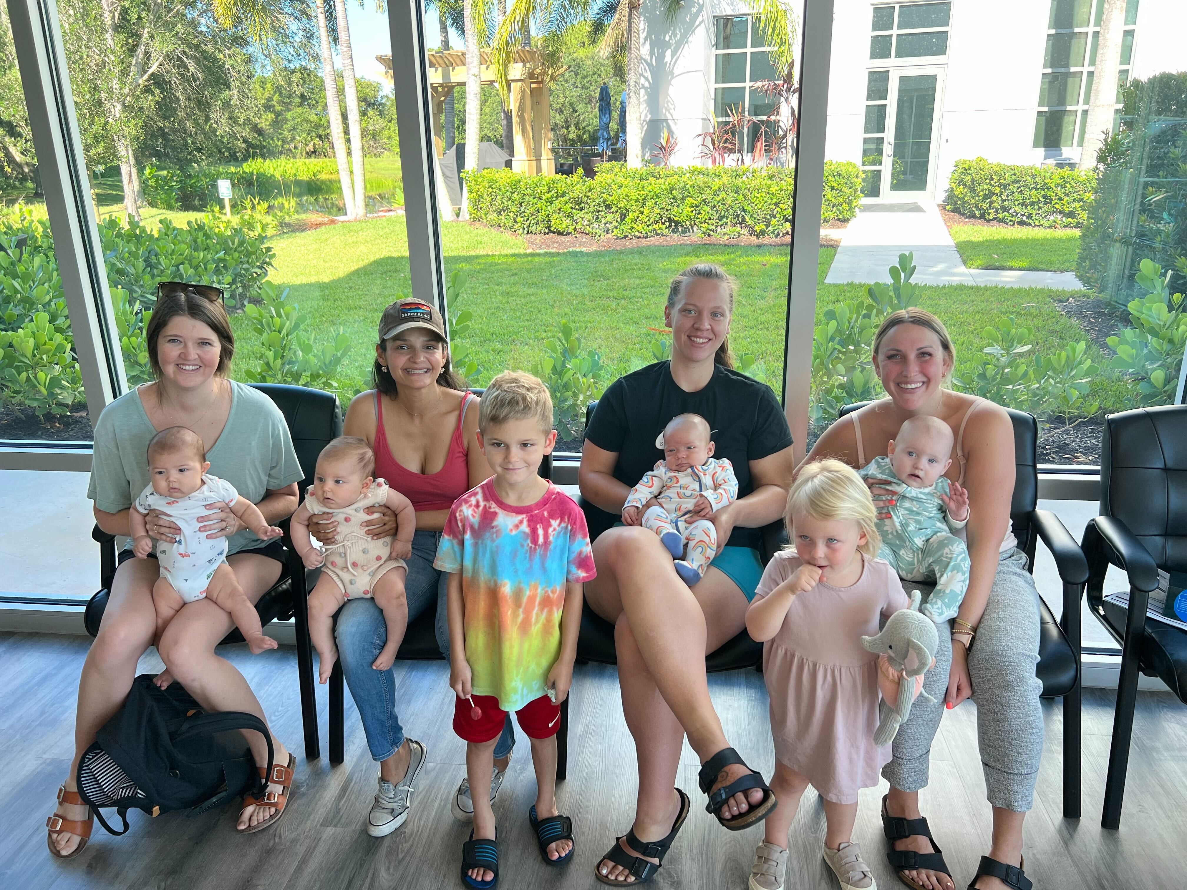 Bright waiting area with families and children, highlighting child-friendly spaces and parenting support during baby chiro...