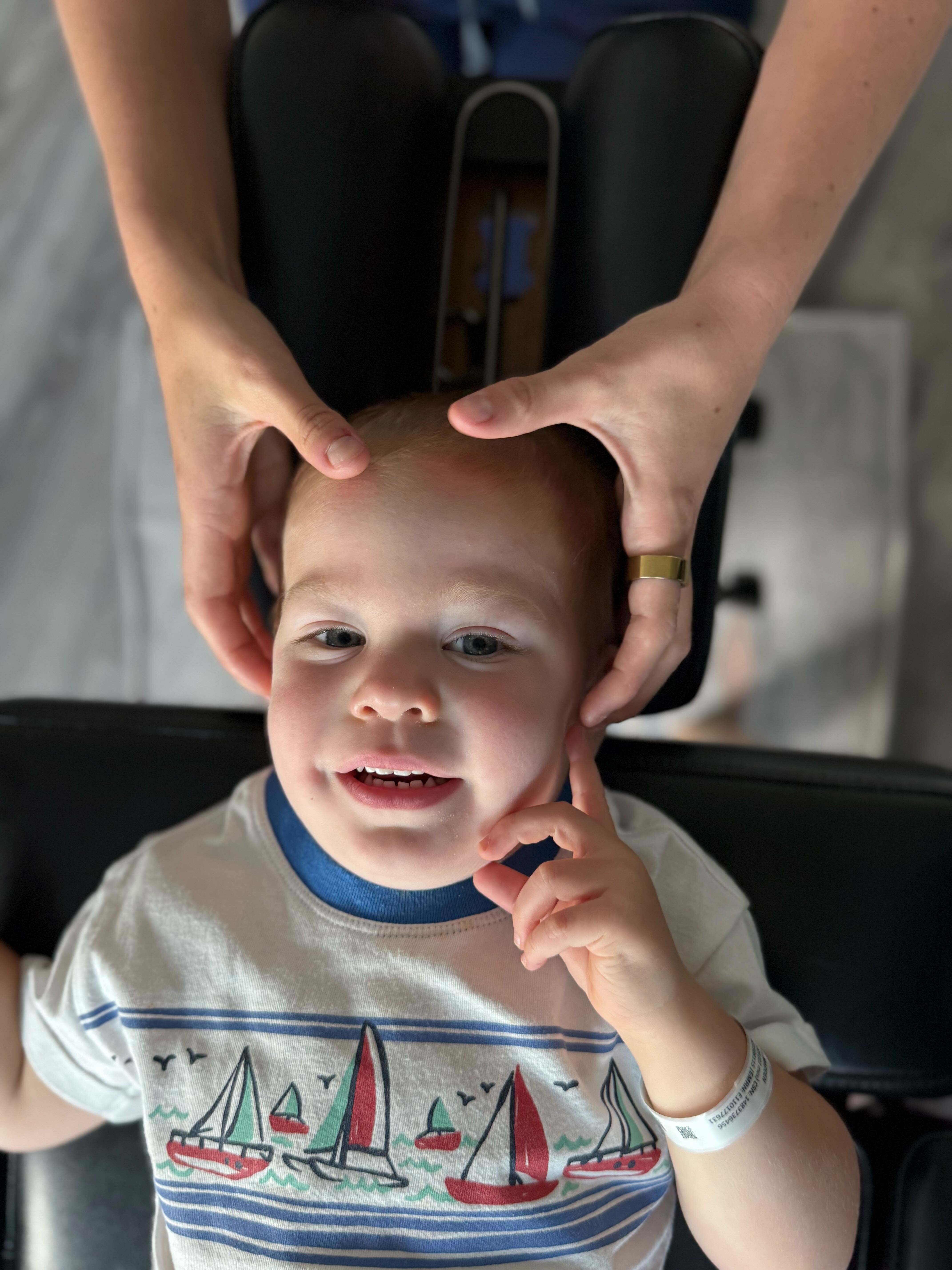 Pediatric chiropractor gently adjusting a child’s neck