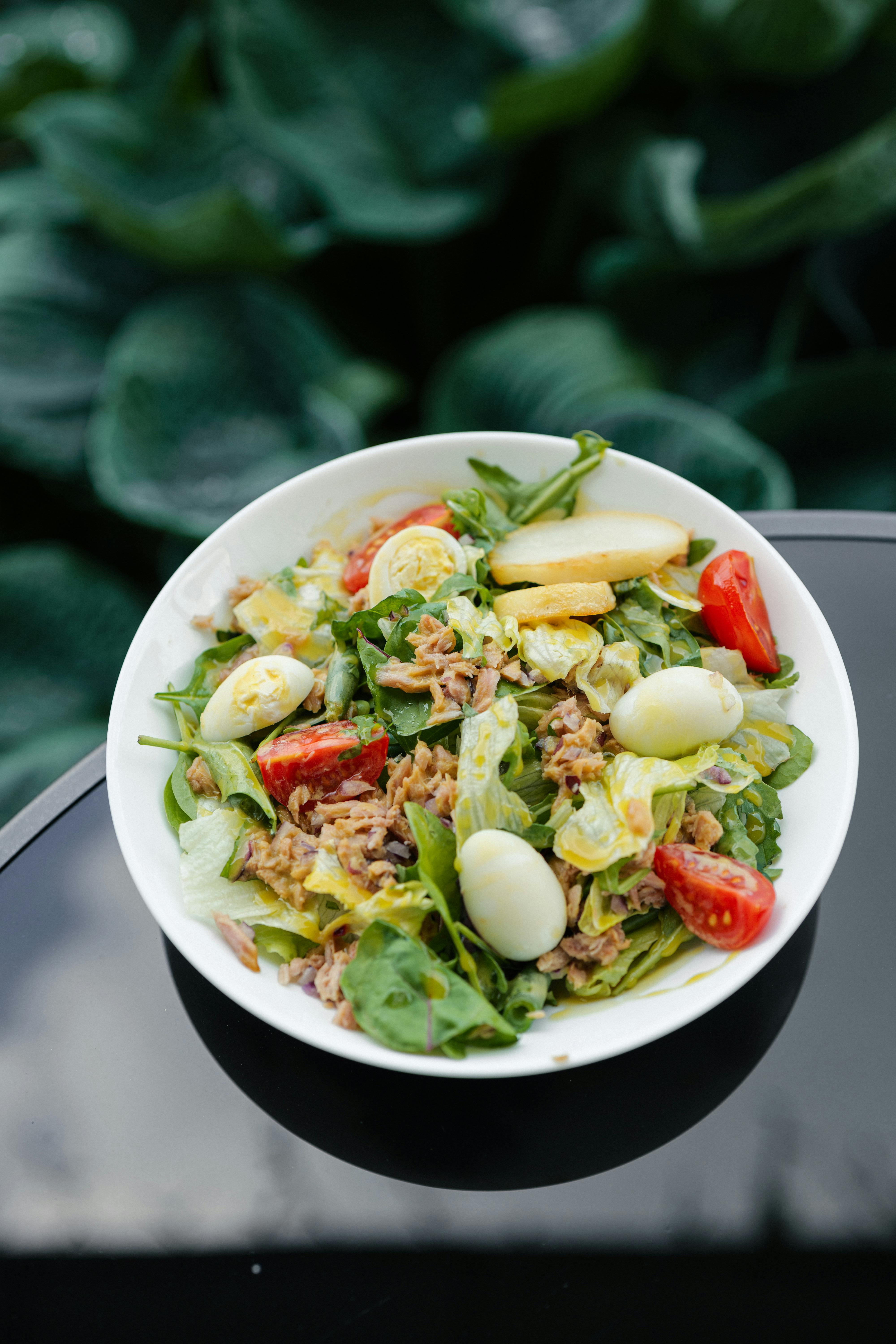 Eggs and leafy greens as choline-rich foods next to vitamins