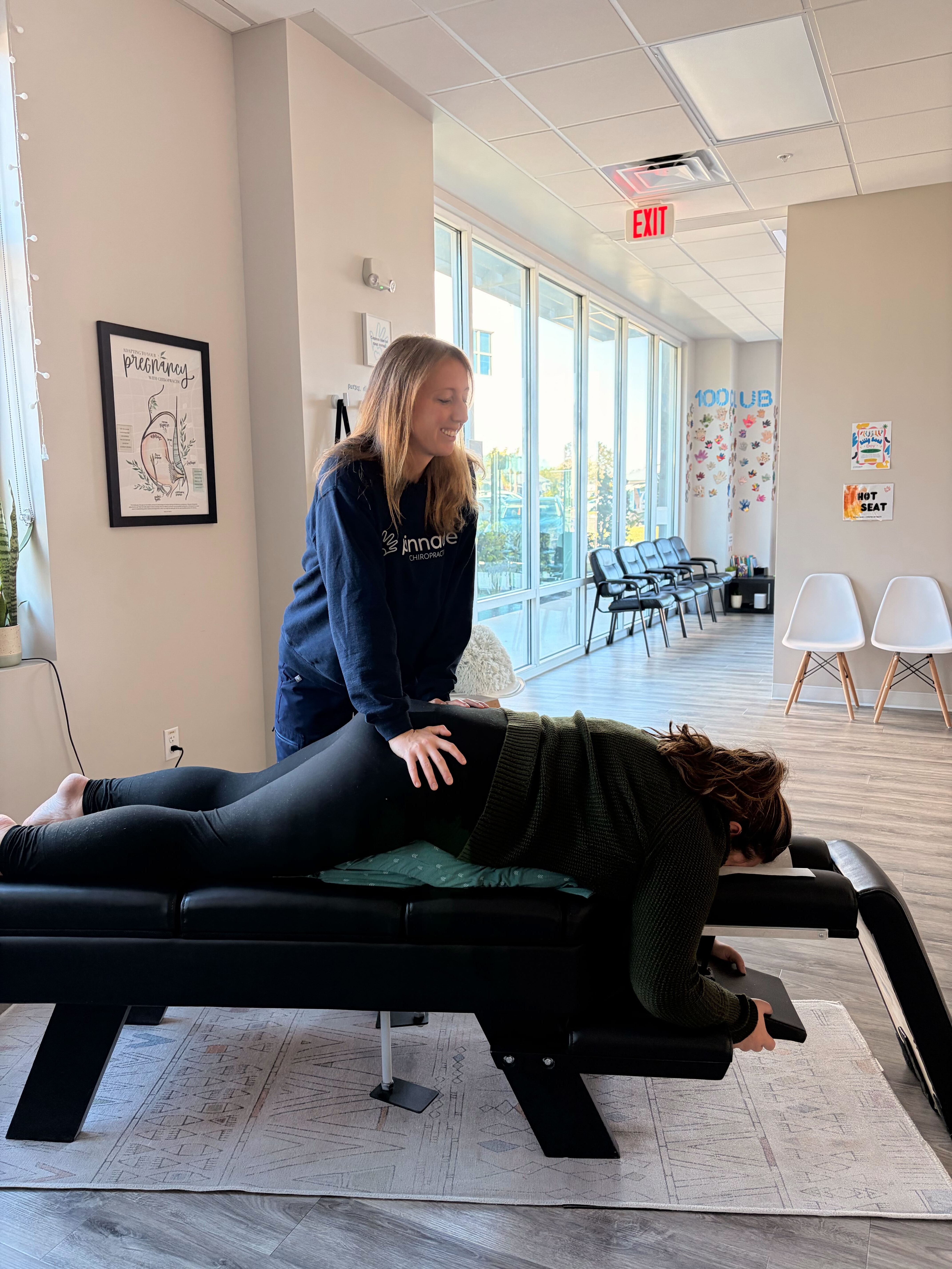 Pregnant mother receiving gentle Webster Technique chiropractic adjustment to support pelvic balance and optimal baby positioning naturally.