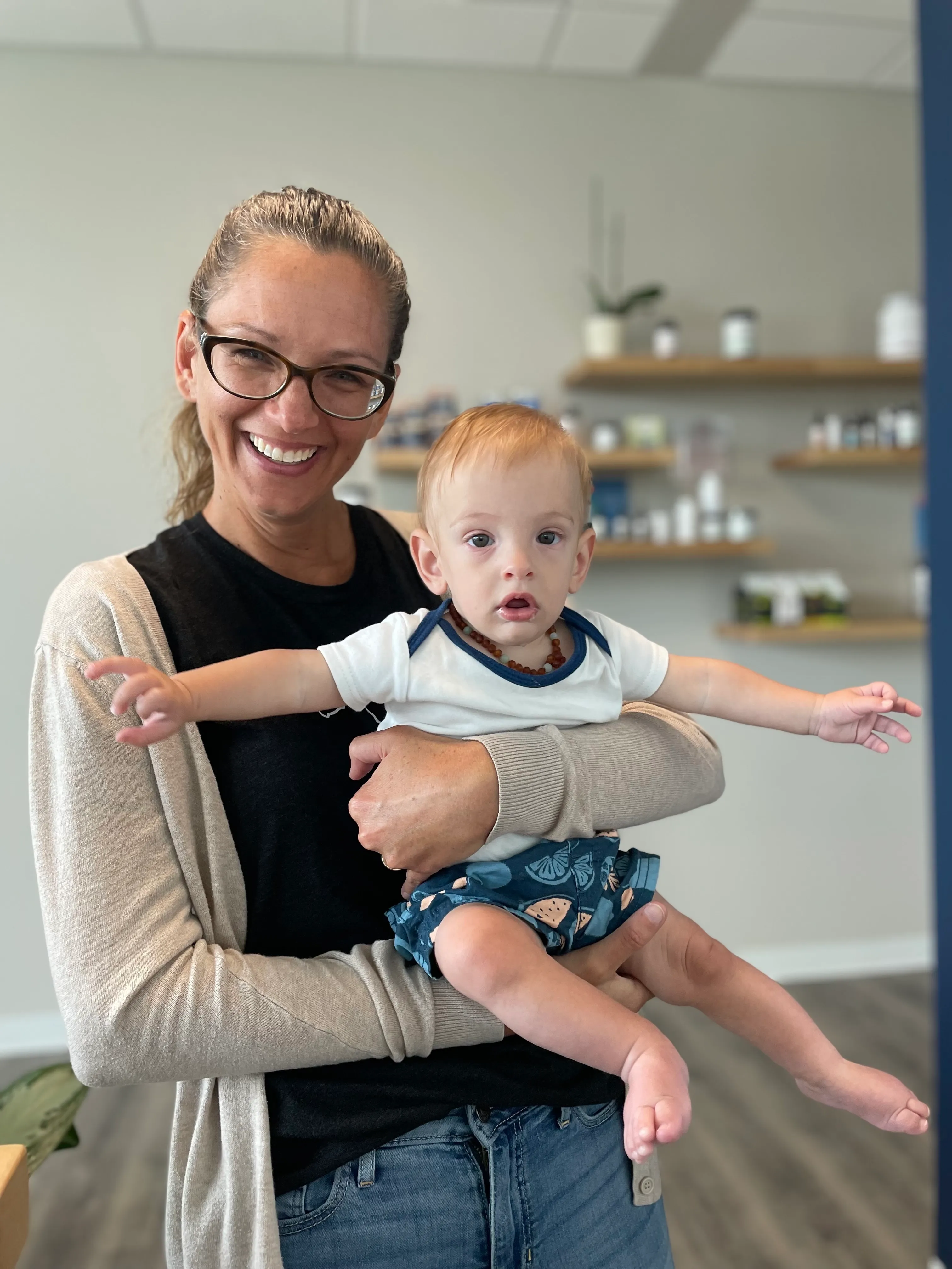 A parent holding a child at Pinnacle Chiropractic