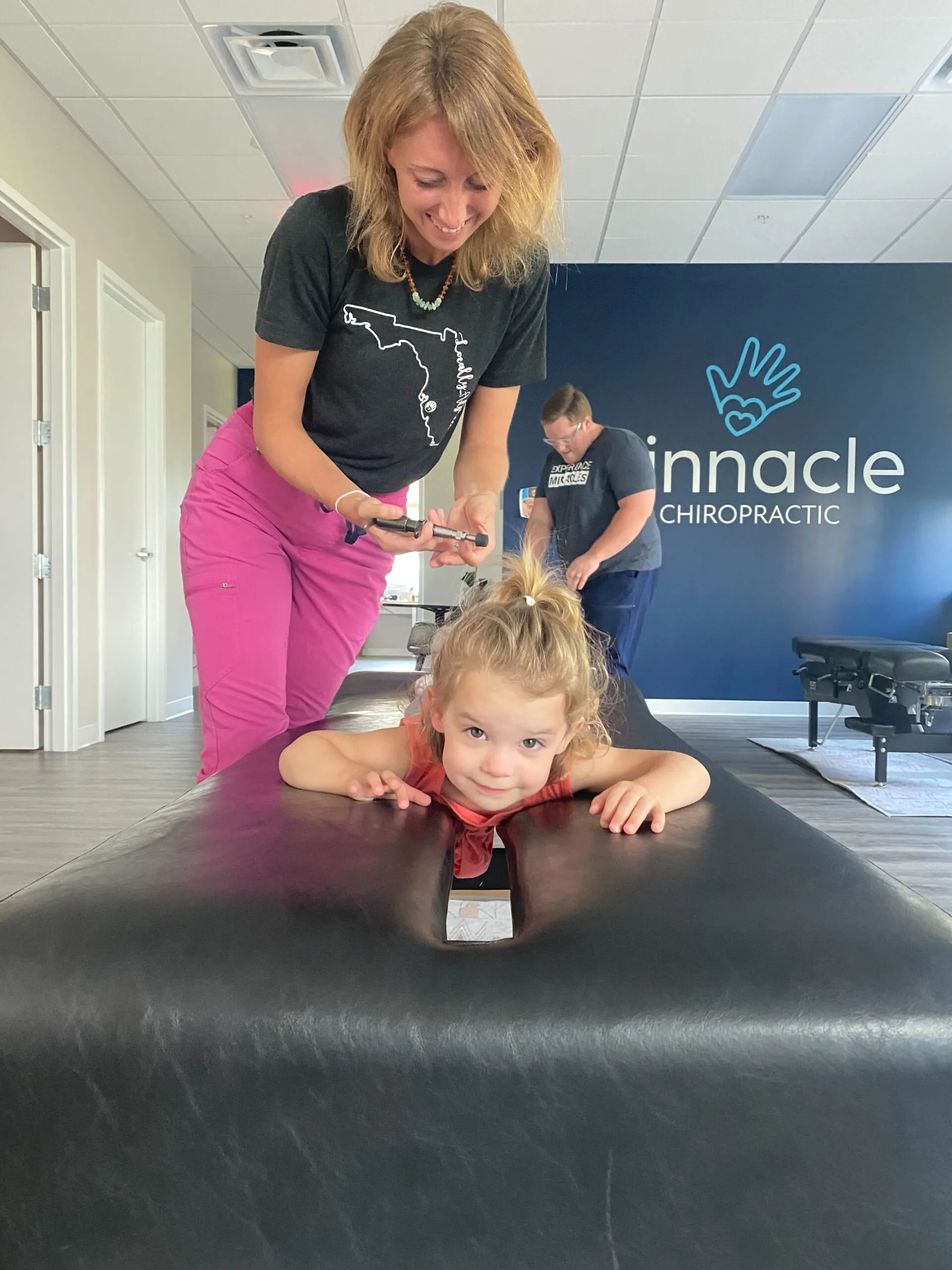 Toddler receiving a gentle chiropractic adjustment at Pinnacle Chiropractic