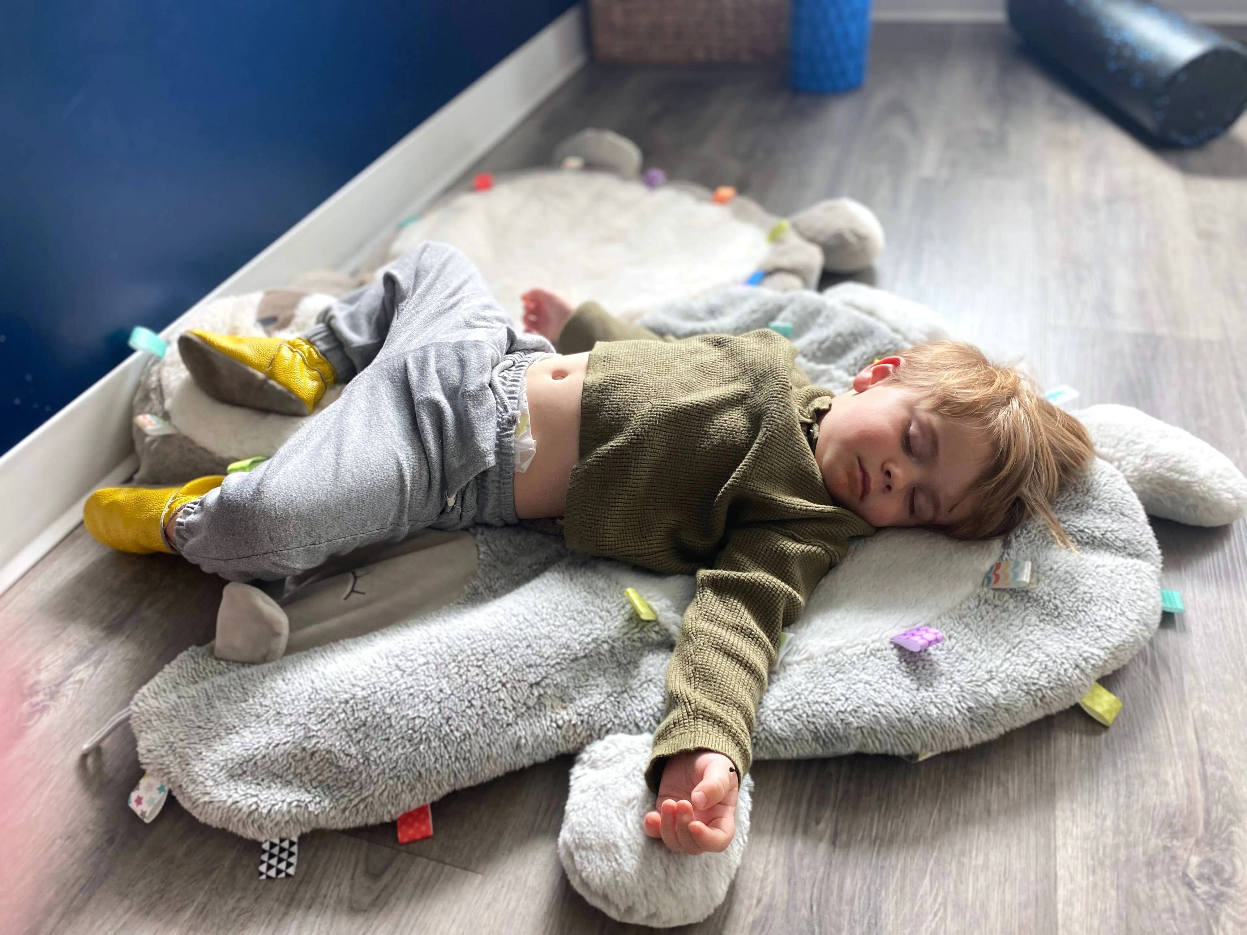 Baby exploring floor time and building strength during supervised tummy time play