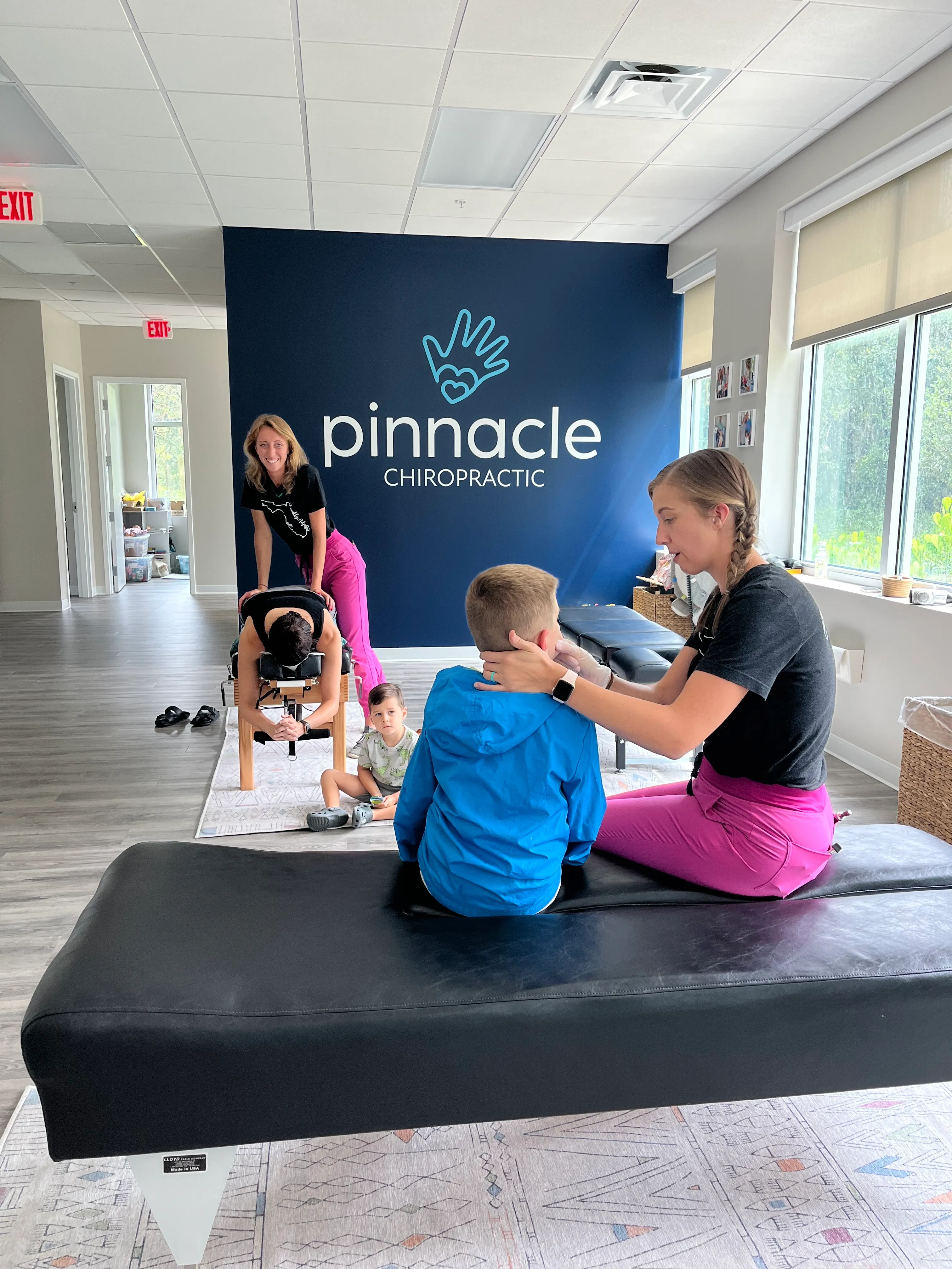 Pinnacle Chiropractic team members adjusting children in the office