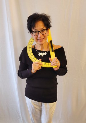 Judith Felice holding a large yellow protractor