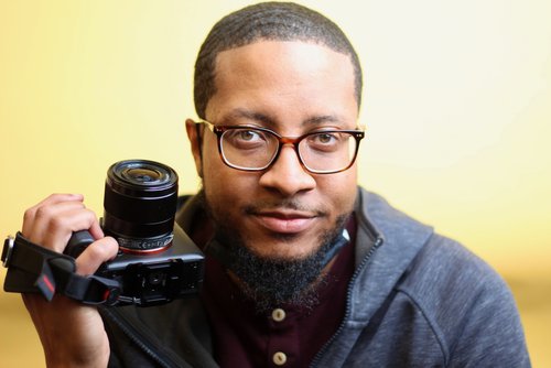 Philip Small faculty member holding a professional camera