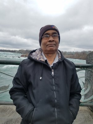 Abmmominur Rahman staff member posing outdoors near waterfall