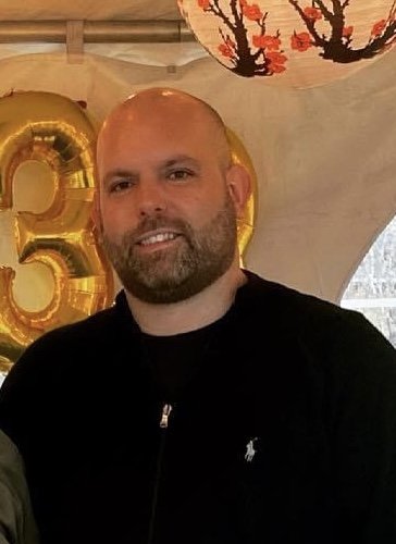 Peter Xanthus smiling at a celebration event