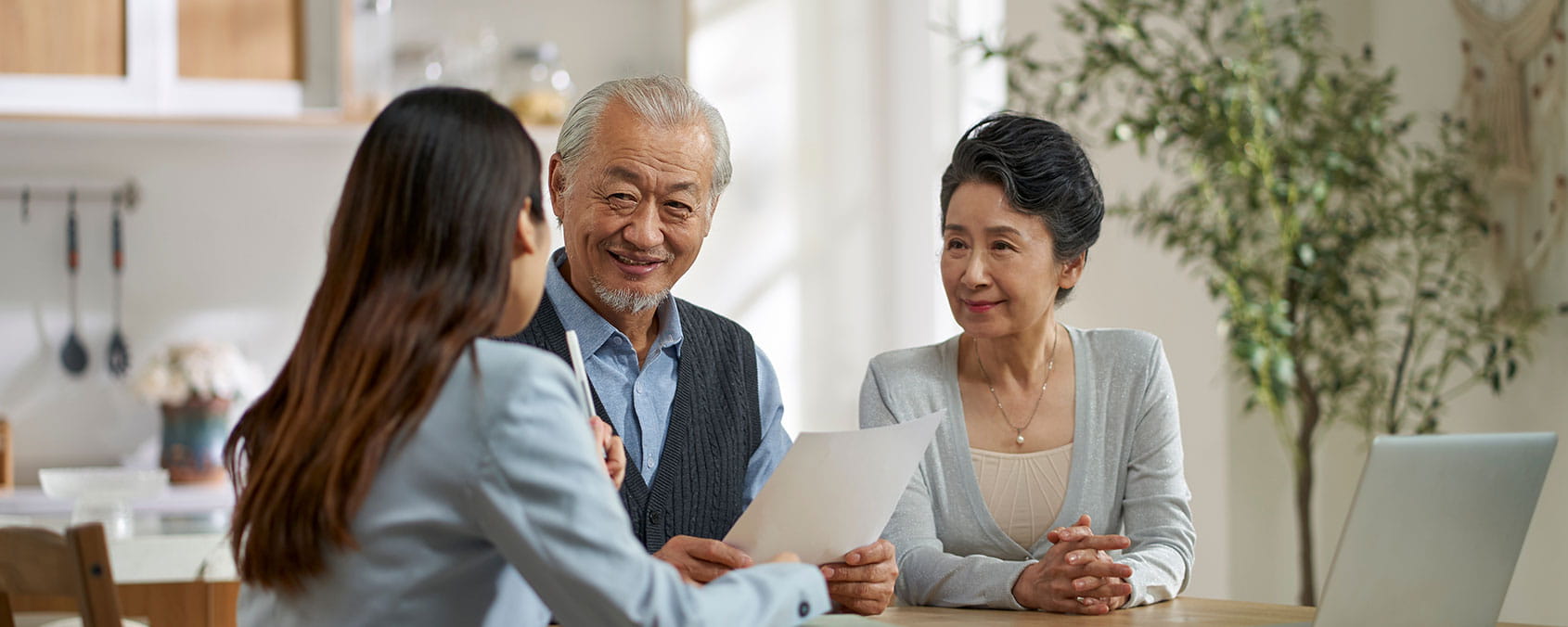 Chinese family discussing offshore trust and wealth planning with a private client adviser.