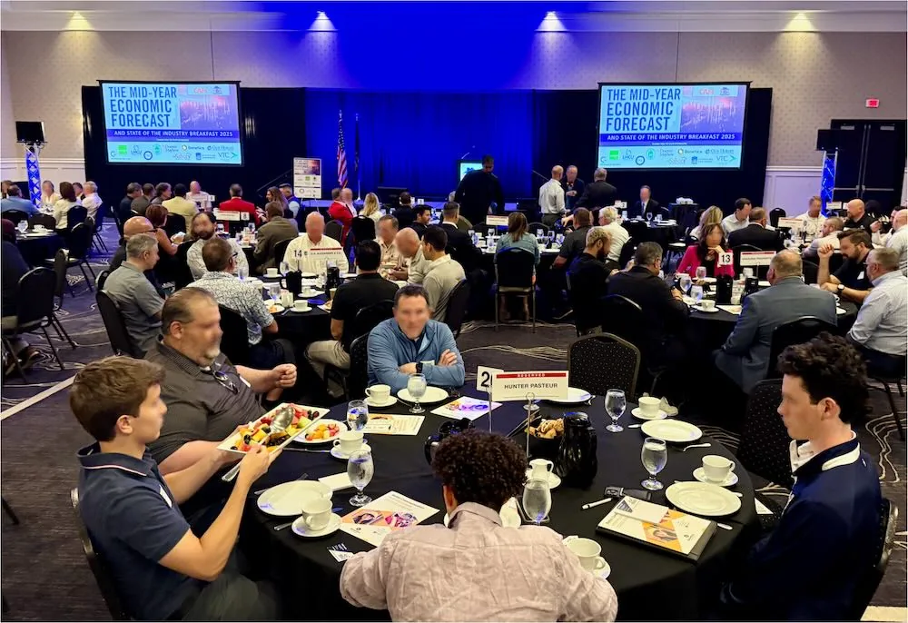 Attendees seated at round tables during the Mid-Year Economic Forecast breakfast event