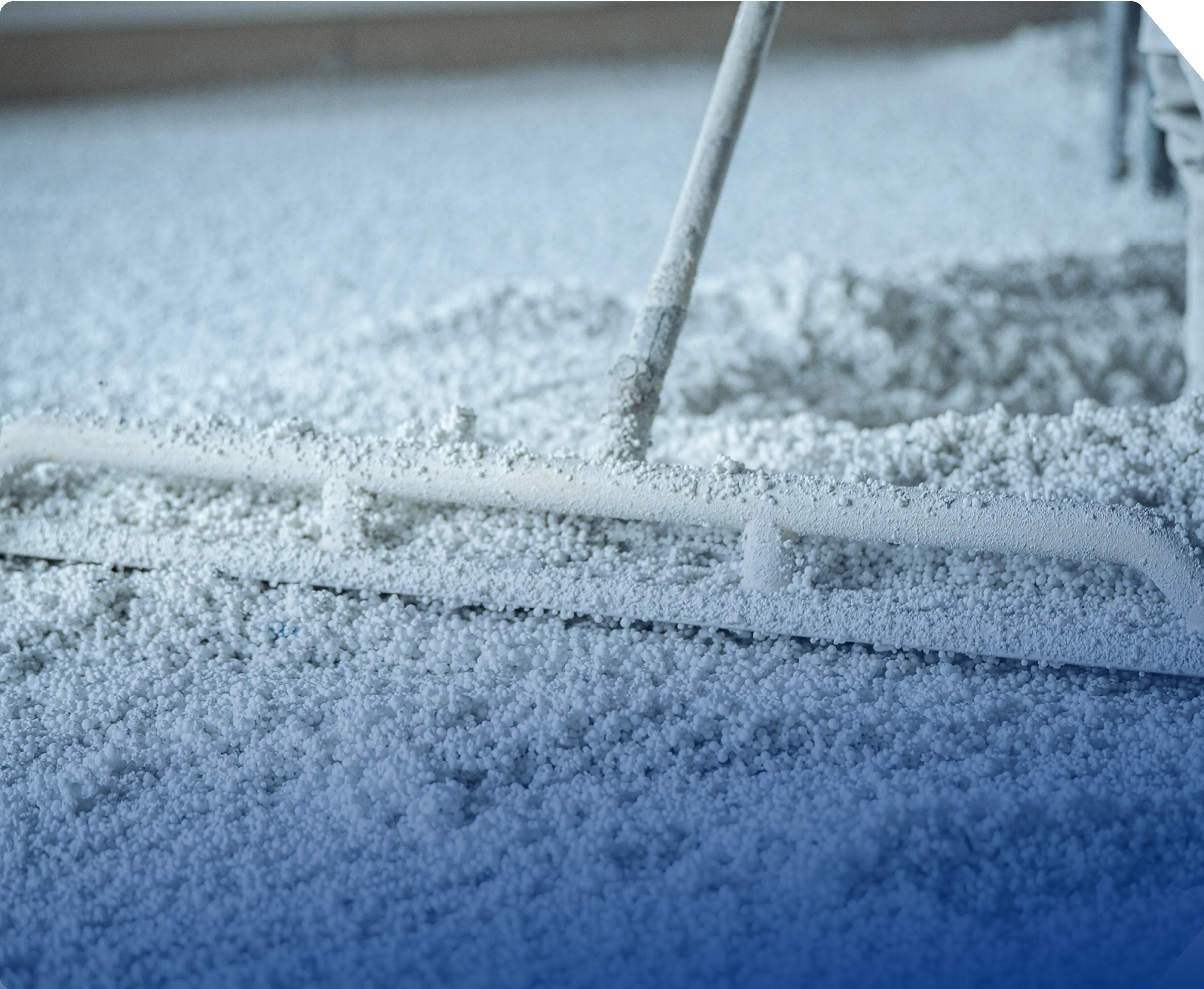 a blue car covered in snow with a broom sticking out of it