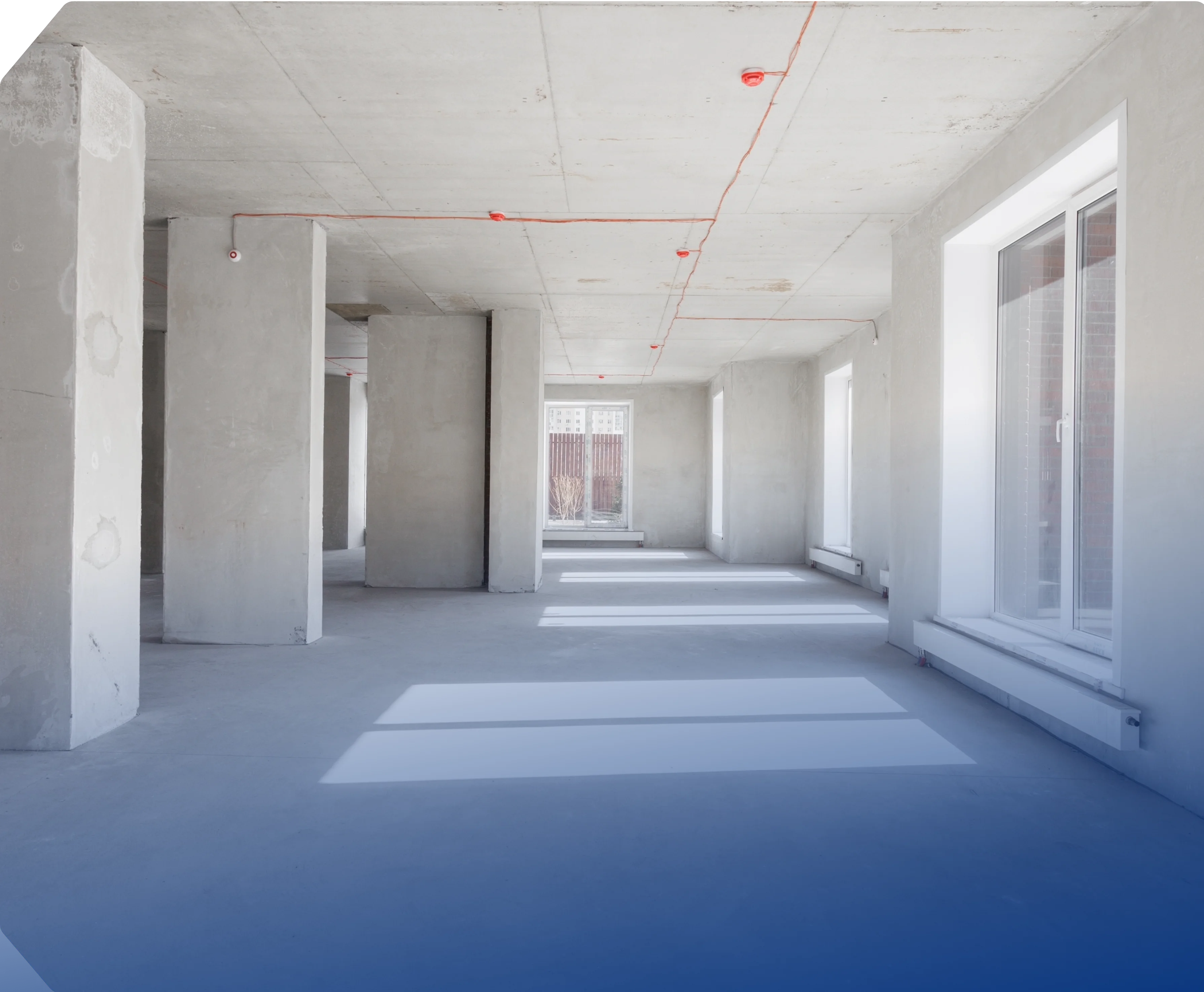 an unfinished commercial or residential space with exposed concrete walls, floors, and ceilings