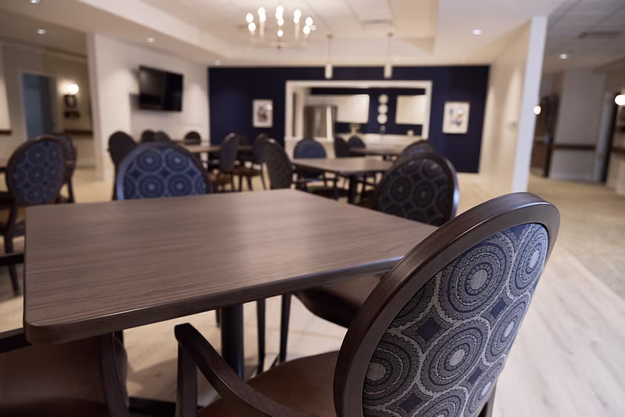 Modern open-concept living room and kitchen at GentleBrook Assisted Living South, showcasing comfortable senior apartments and amenities.