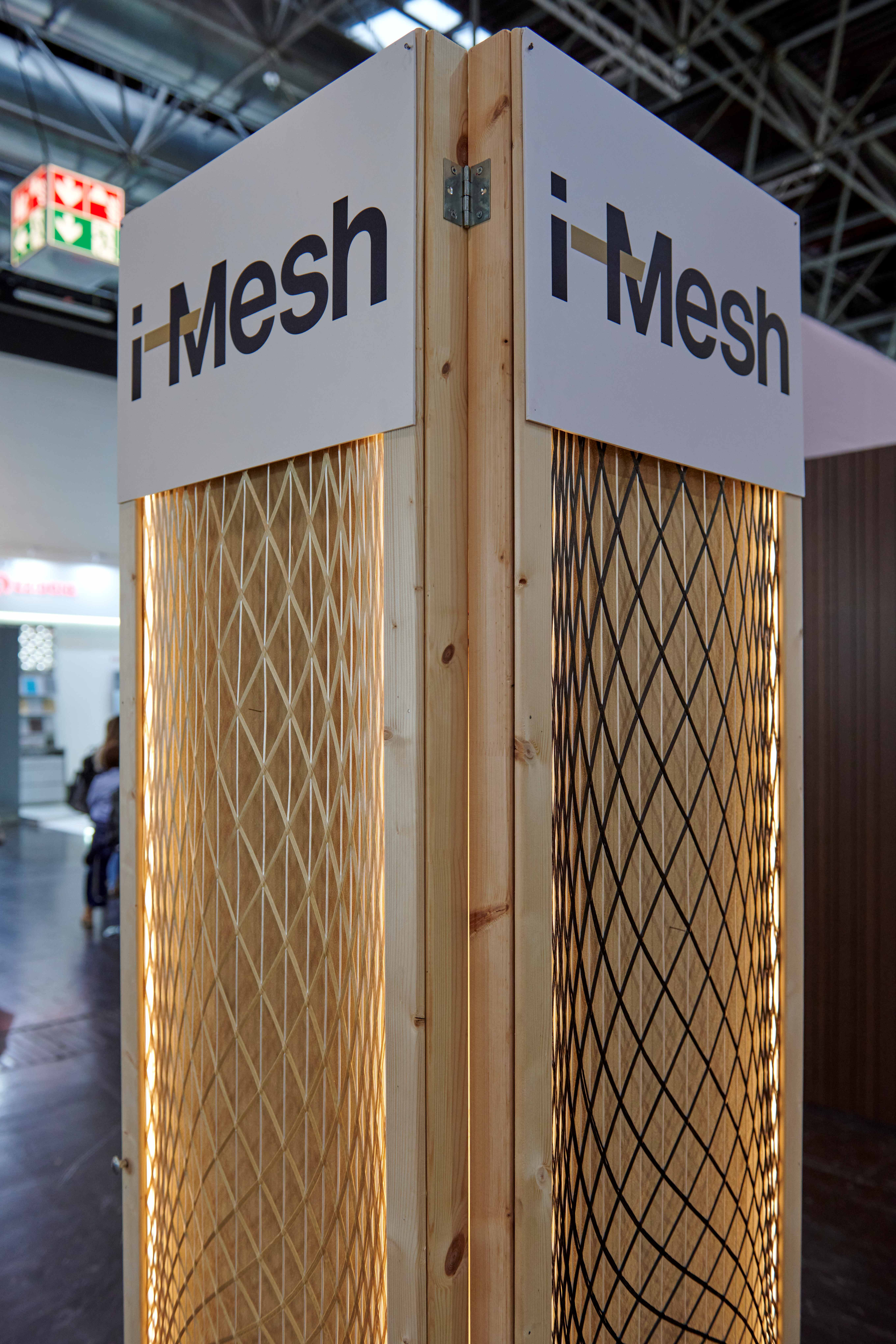 i-Mesh backlit architectural mesh panels on wooden display totem at Euroshop 2026
