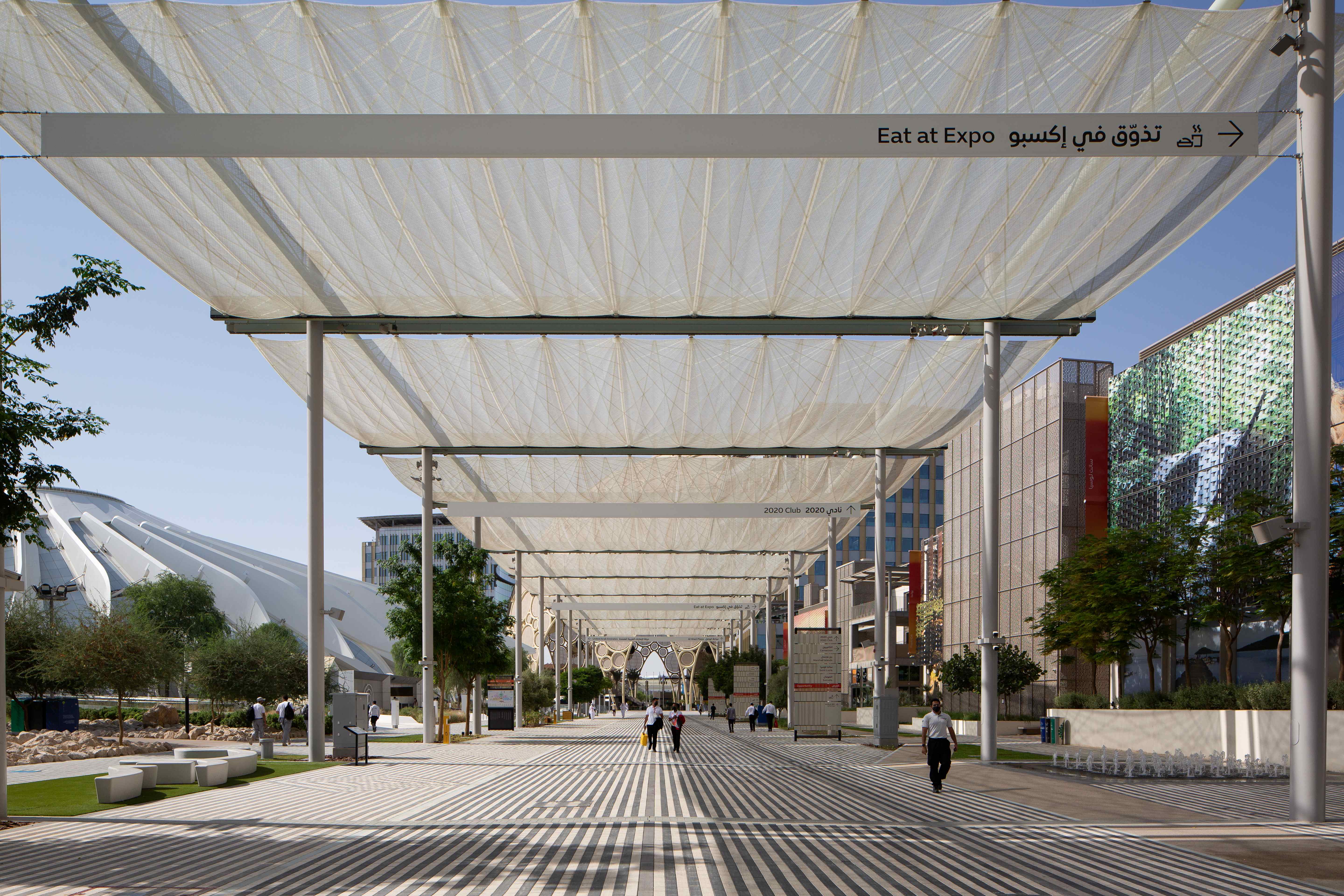 Perspective view of the Thematic Concourse at Expo 2020 Dubai entirely shaded by the i-Mesh retractable solar shading system, the longest covered pedestrian walkway ever built