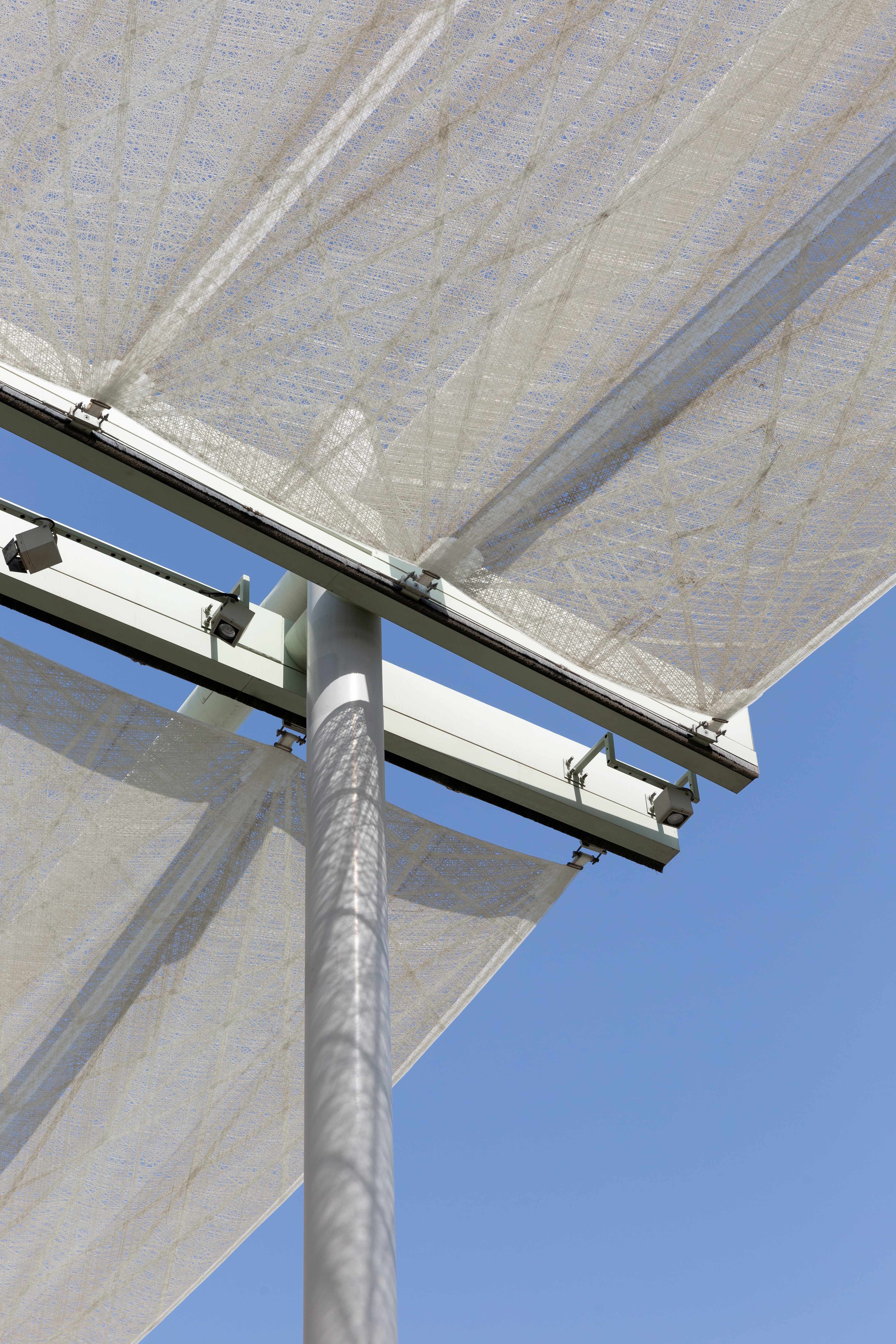 Bottom-up view of the i-Mesh technical fabric attachment system to the metal structure of the retractable pergola at Expo 2020 Dubai