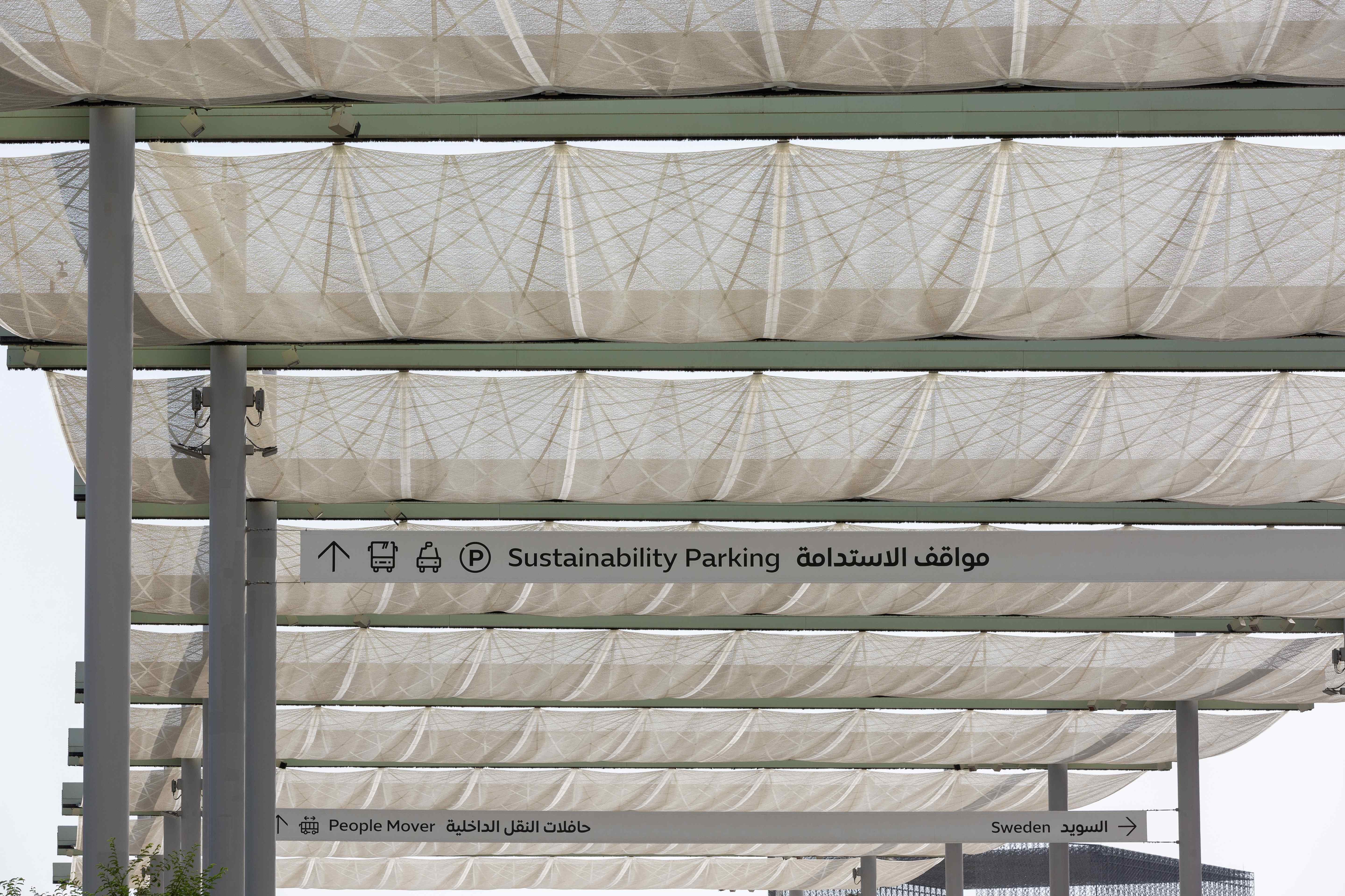 i-Mesh technical fabric panels in retracted position on the metal structure of the retractable pergola at Expo 2020 Dubai, Sustainability Parking area
