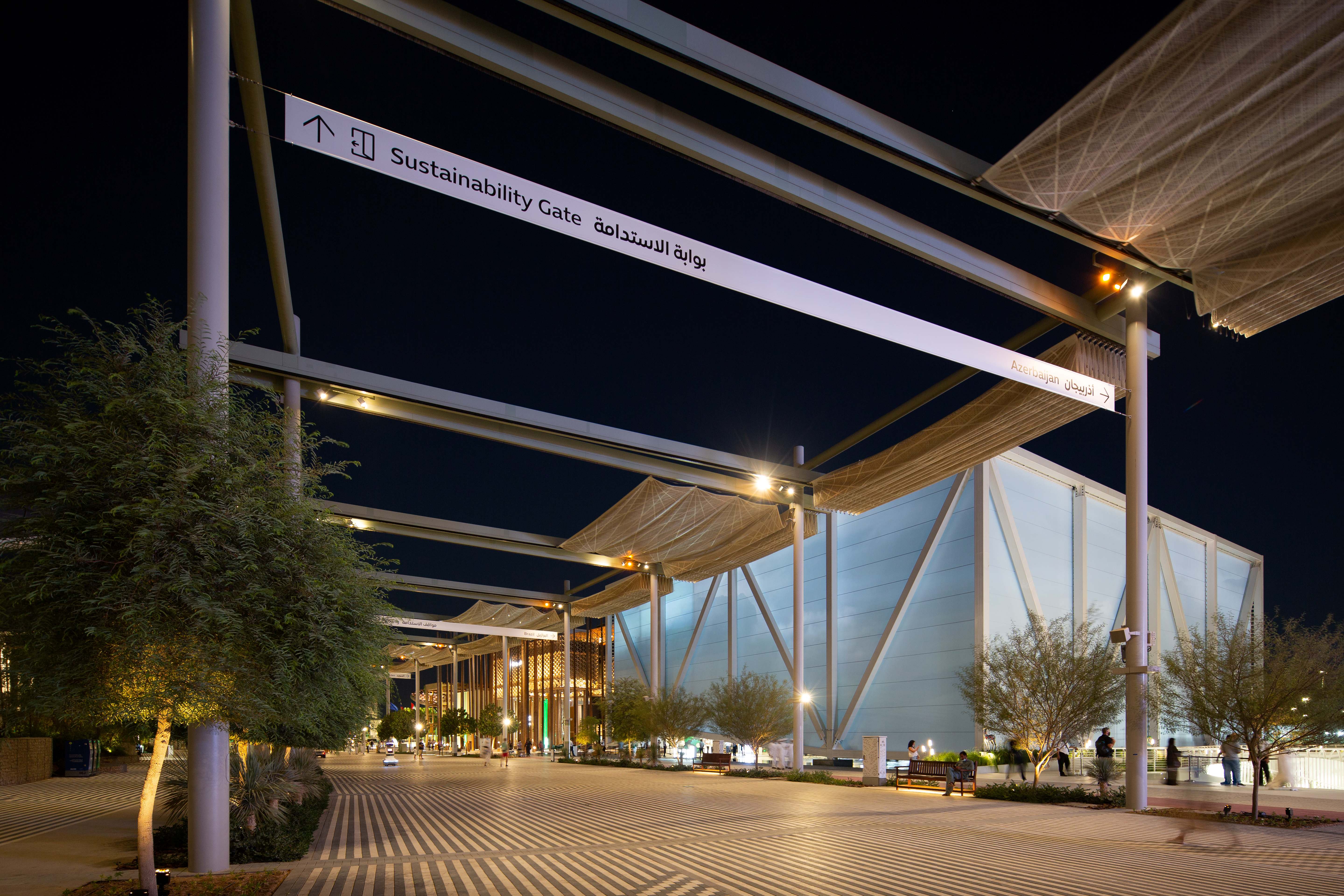 Nighttime view of the i-Mesh retractable shading structure in closed position at Expo 2020 Dubai, Sustainability Gate area, with artificial lighting