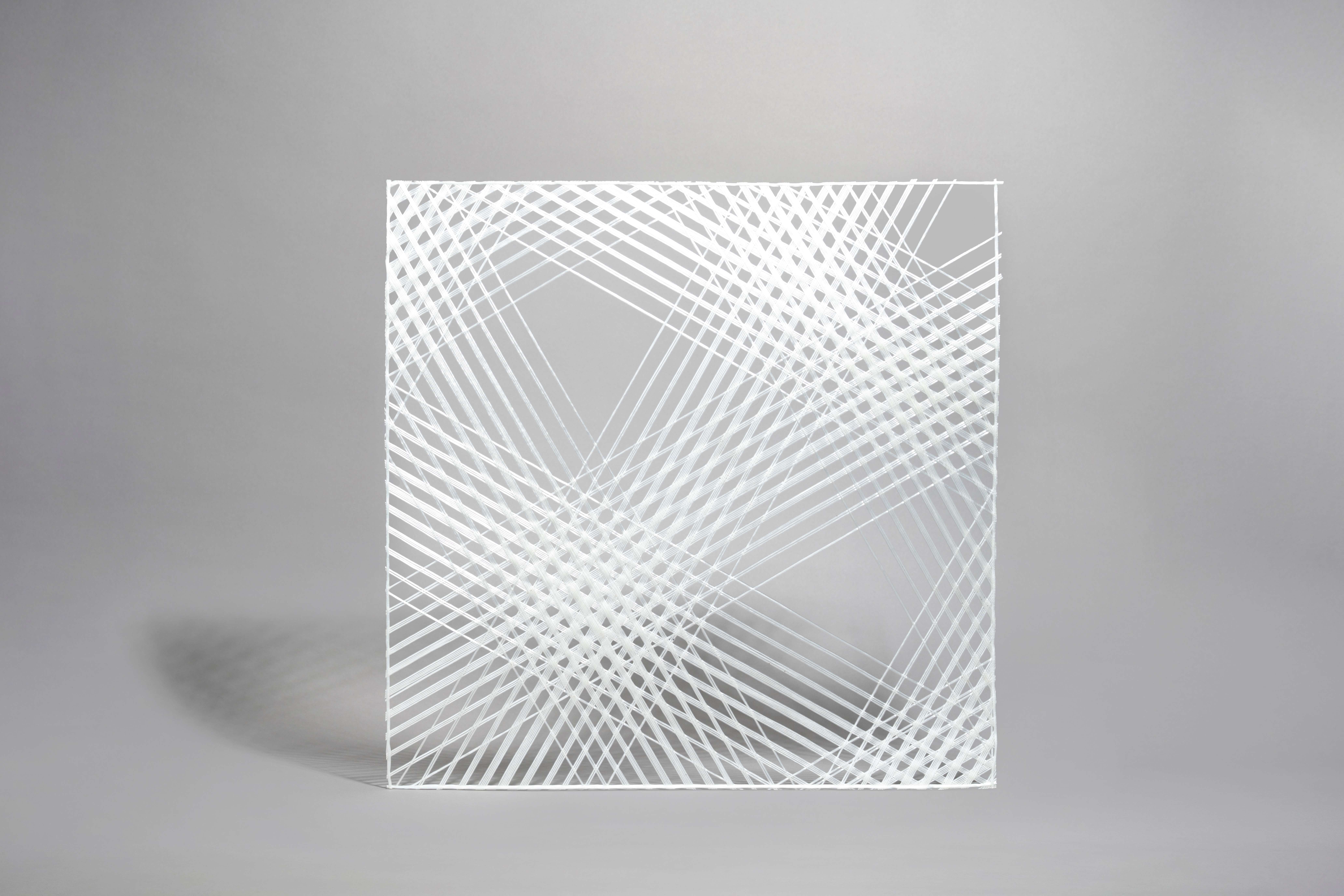 Full view of the one-of-a-kind bespoke i-Mesh pattern designed by Kimihiko Matsuda for HARADA Store in Tokushima — overlapping diagonal lines in white fiberglass on a light background creating a layered geometric composition